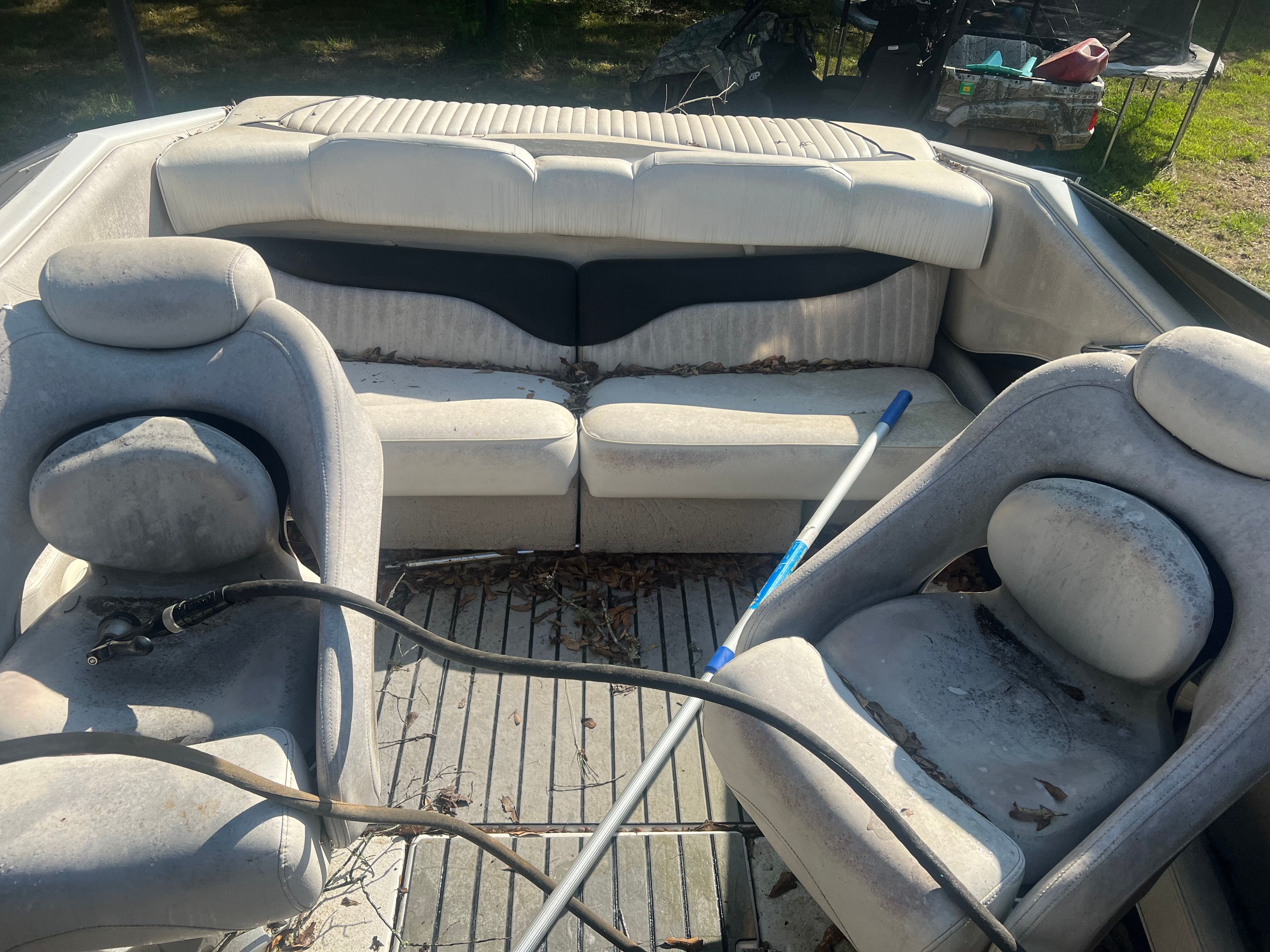 Interior of a 2001 Crownline 202 BR boat with seats and leaves.