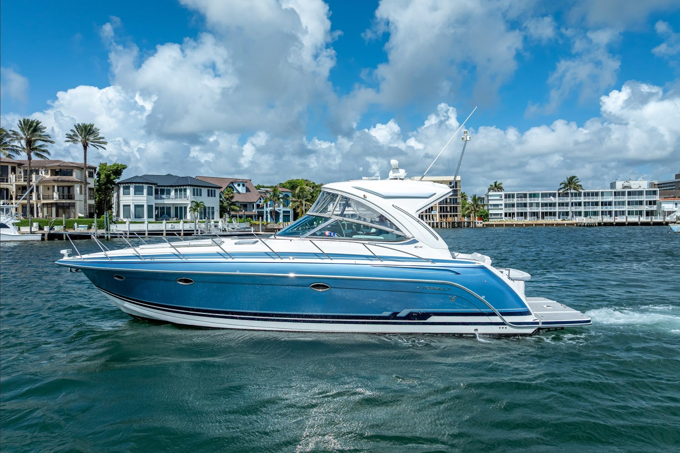 2022 Formula 40 Performance Cruiser on water, with coastal buildings in the background.