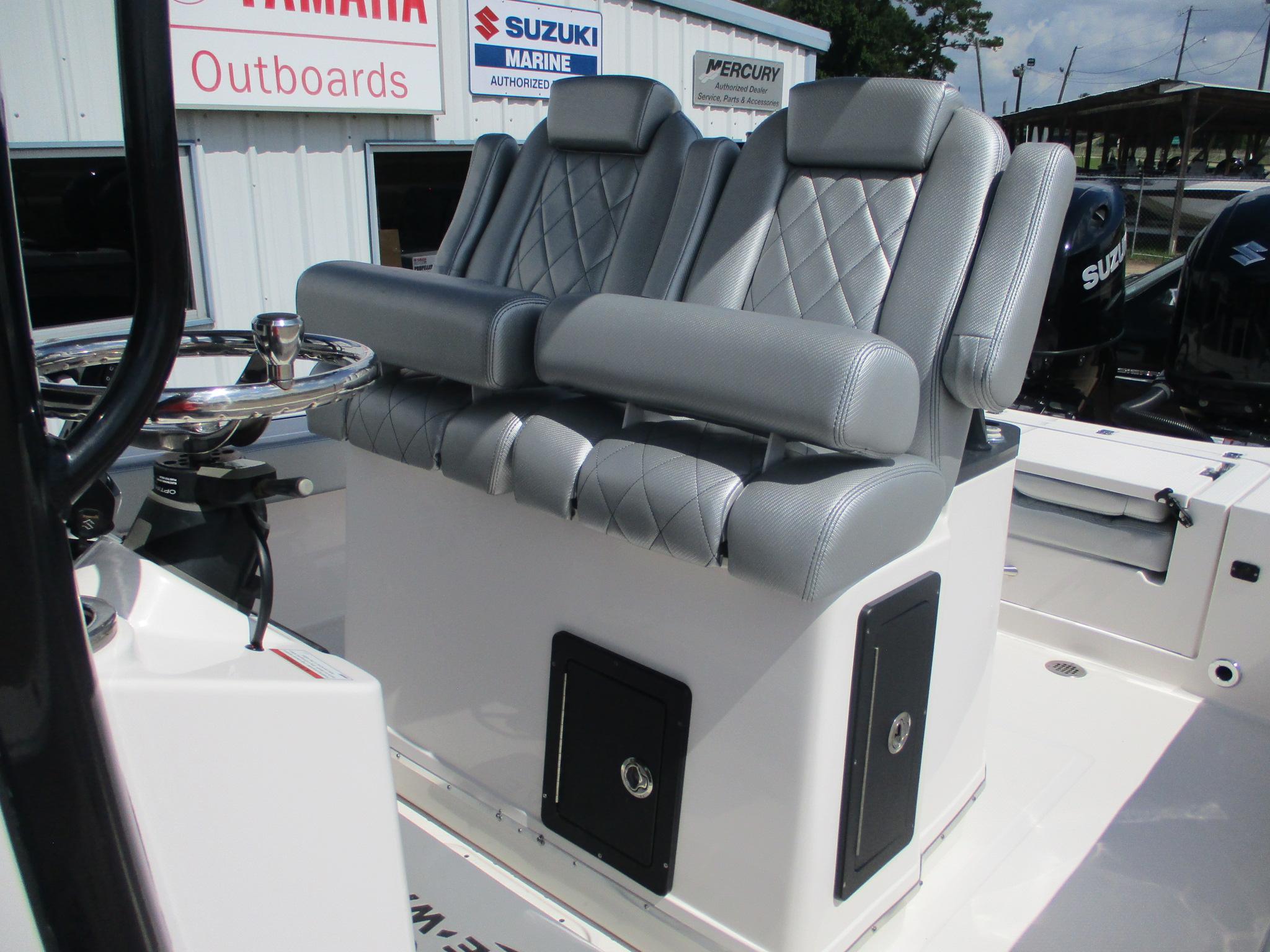 2024 Blue Wave 2800 Makaira boat seats with diamond stitching, near outboard motor signs.
