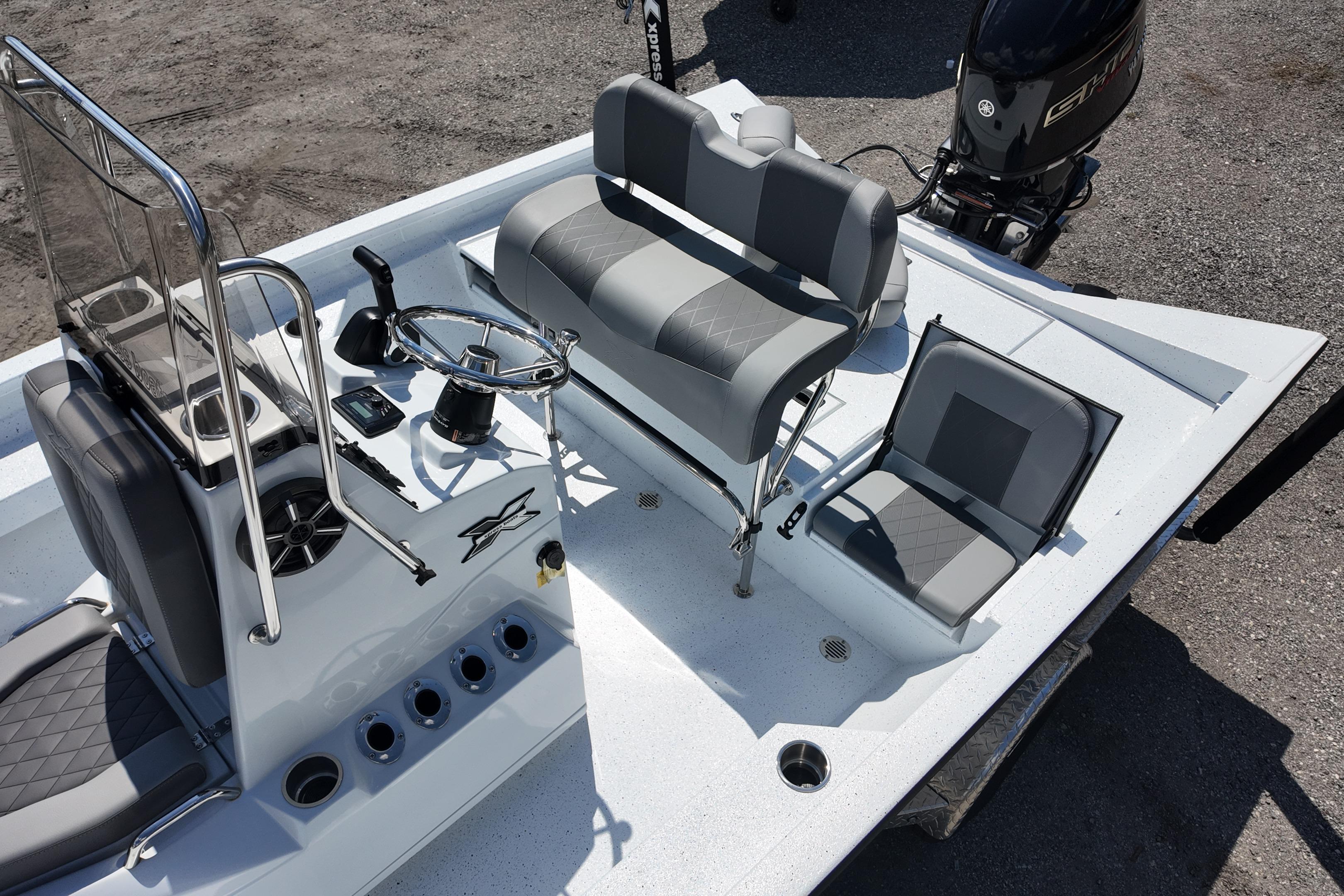 2026 Xpress H20 boat interior with steering console, seating, and motor.