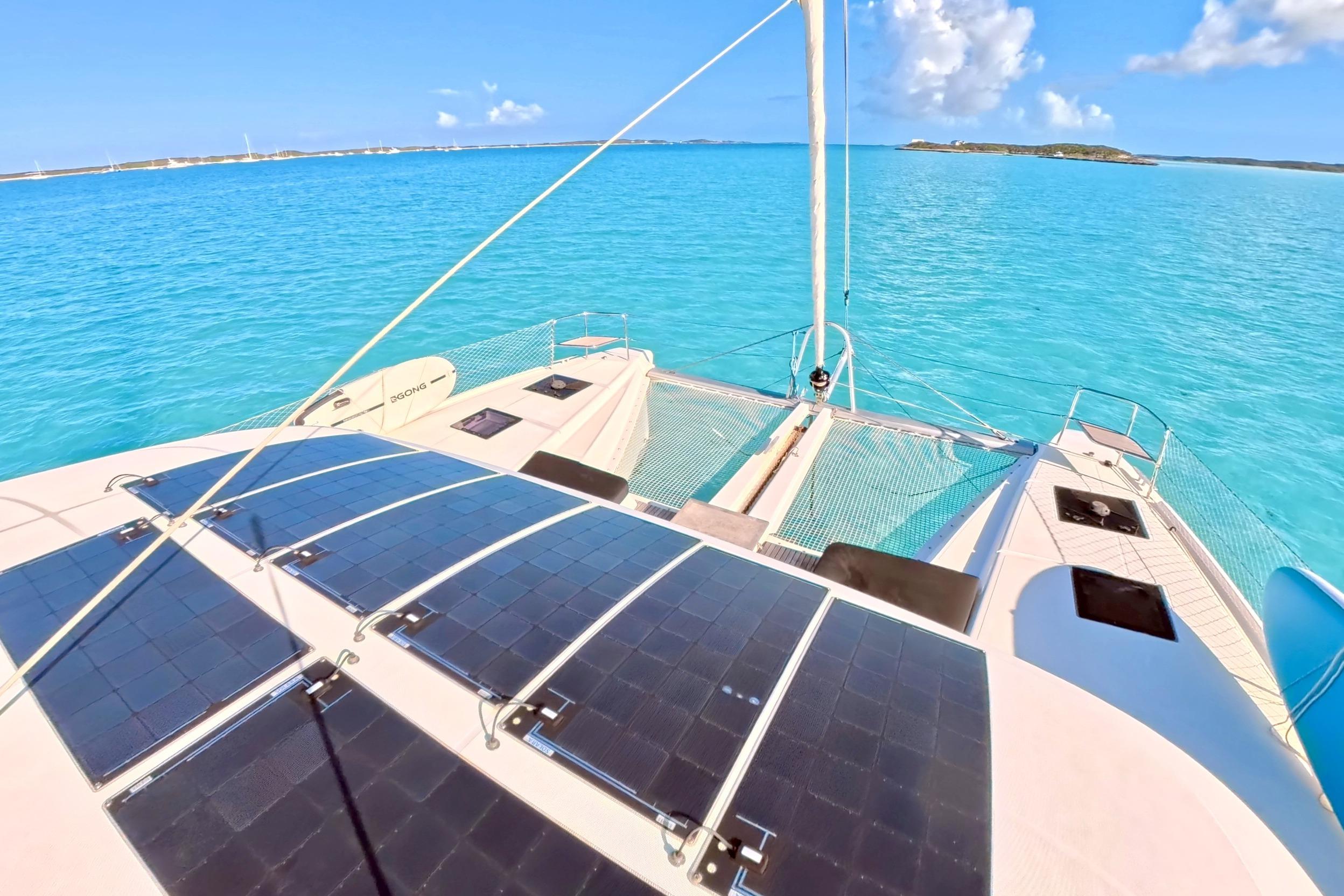 2023 Lagoon 50 catamaran with solar panels on turquoise ocean waters.
