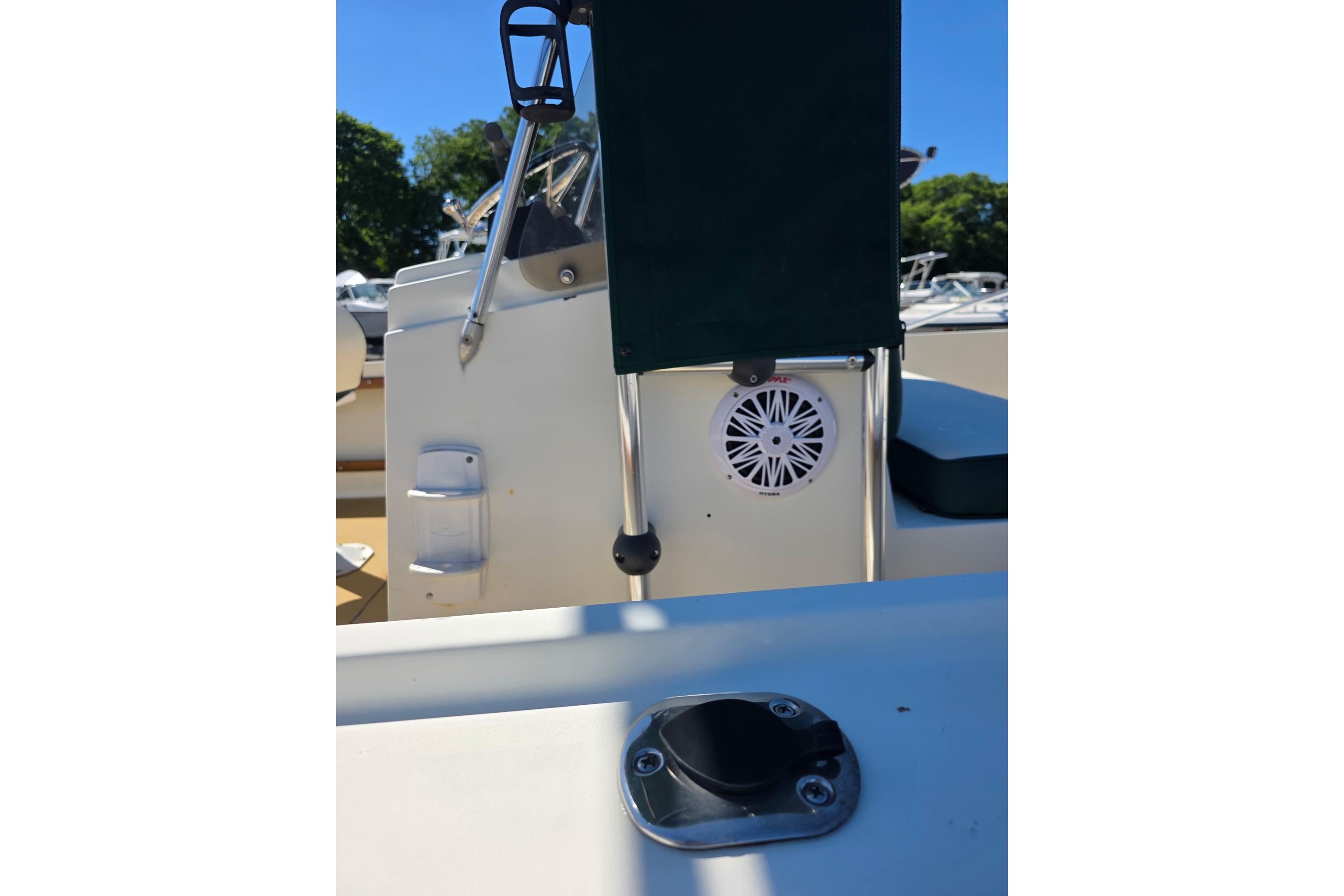 1982 Mako 20 Center Console boat interior with speaker and seating, sunny day.