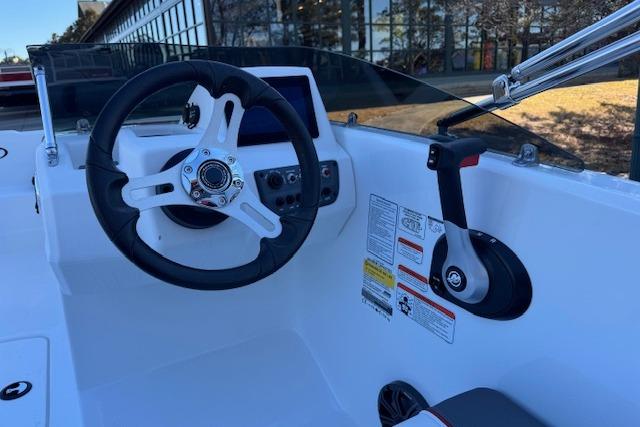 Steering console of 2026 Tahoe T16 boat with modern controls and sleek design.