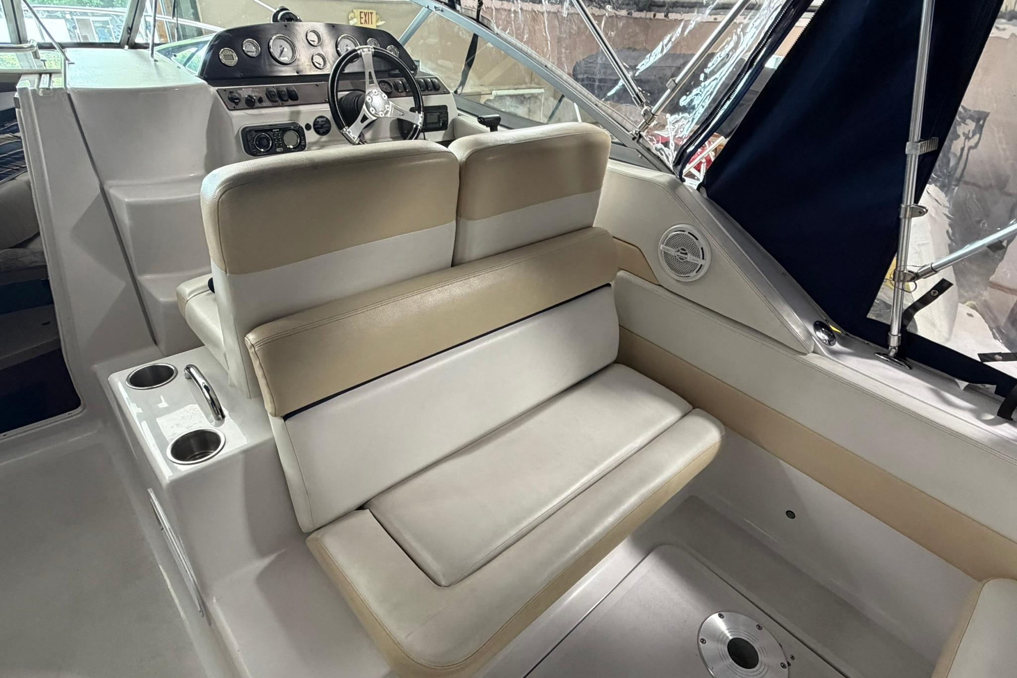 2008 Four Winns V248 boat interior with beige seating and steering console.