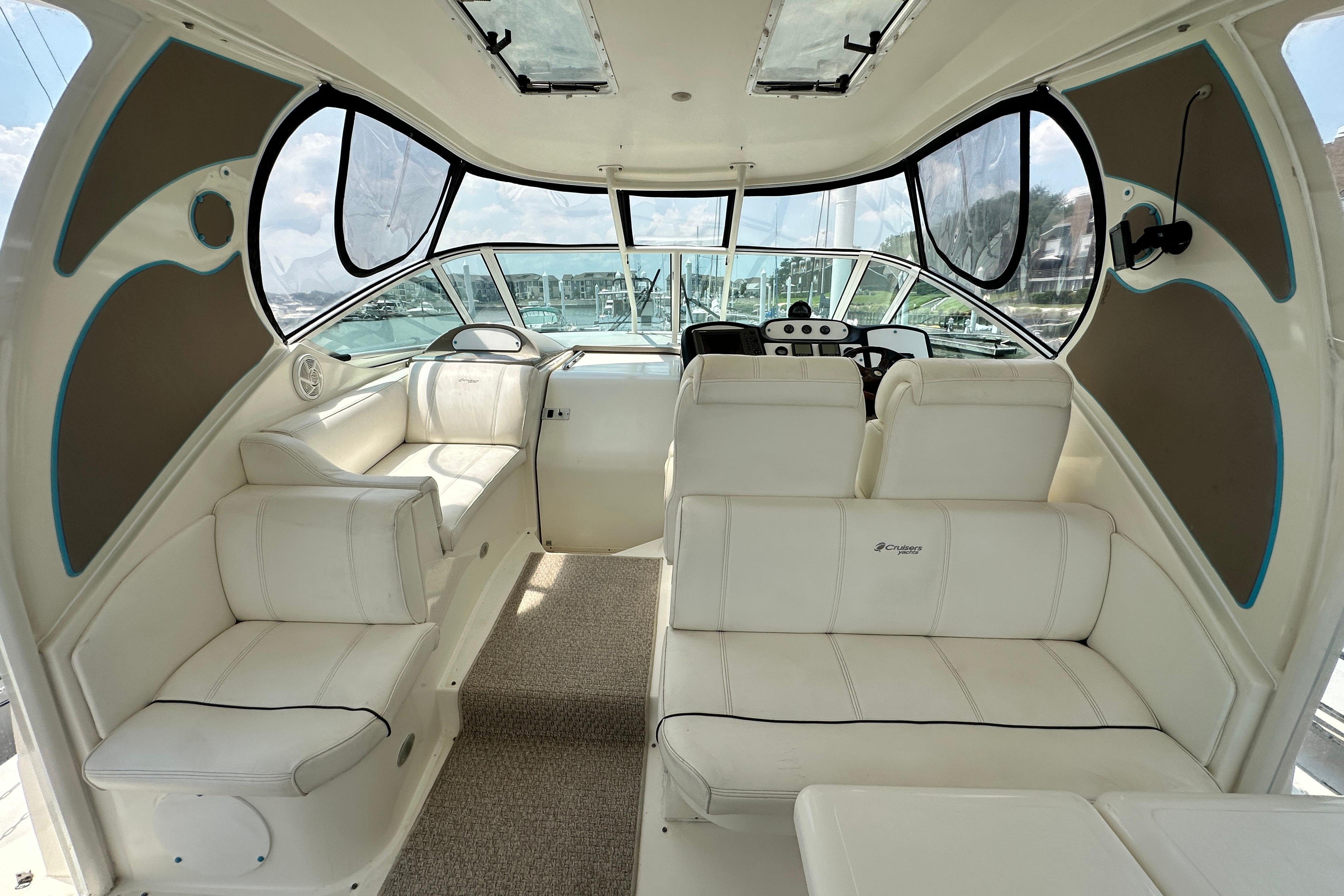 2004 Cruisers Yachts 405 Express Motoryacht interior with white seating and helm.