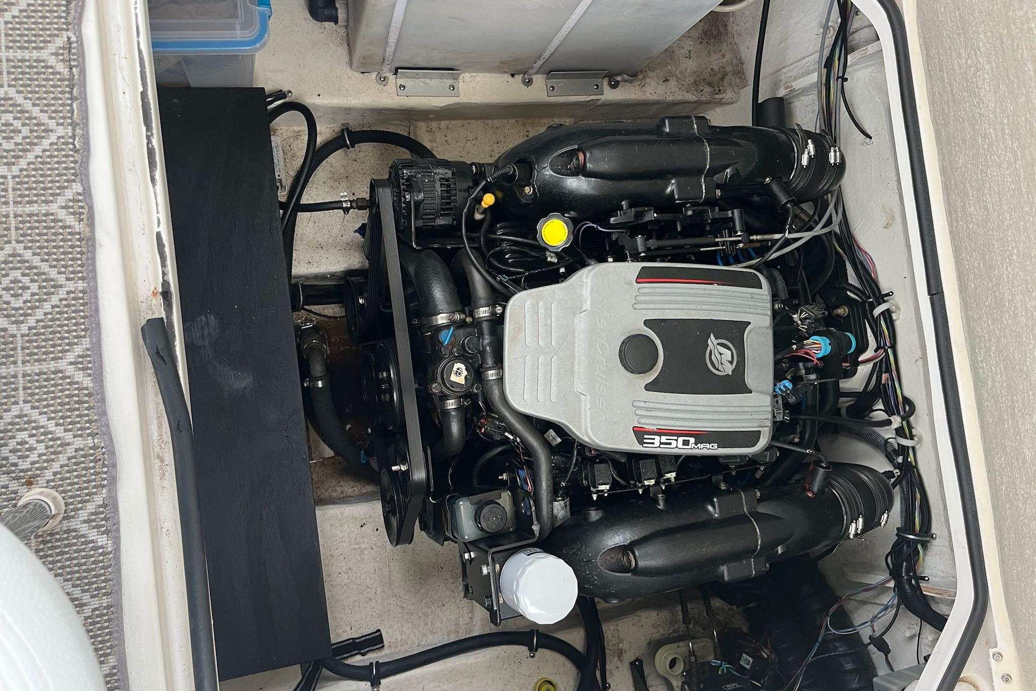 Engine compartment of a 2011 Larson Carbiro 240 boat, featuring a 350 MAG engine.