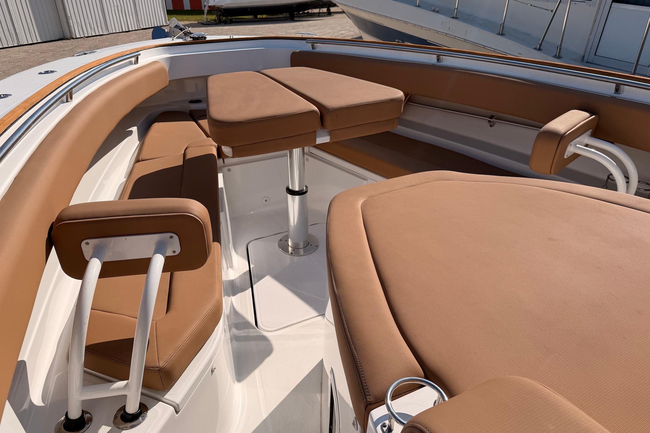 Luxurious seating area on a 2022 HCB 42 Lujo boat with tan upholstery.