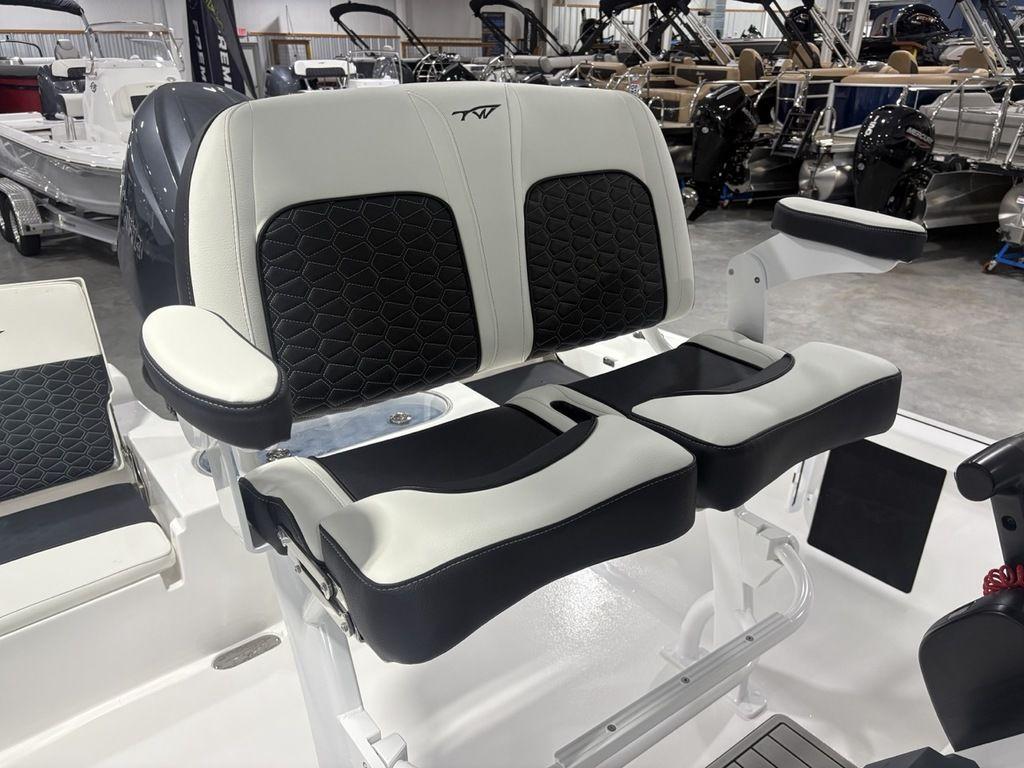2026 Tidewater 2110 BM boat seats with black and white upholstery in a showroom.