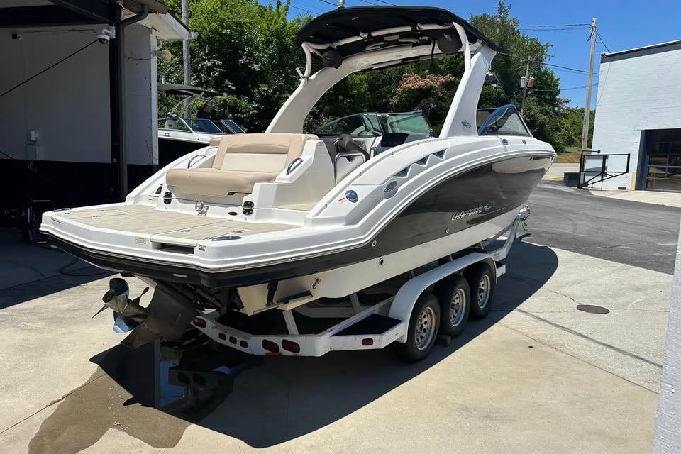 2012 Chaparral 284 Sunesta boat on trailer, parked outdoors in a sunny setting.