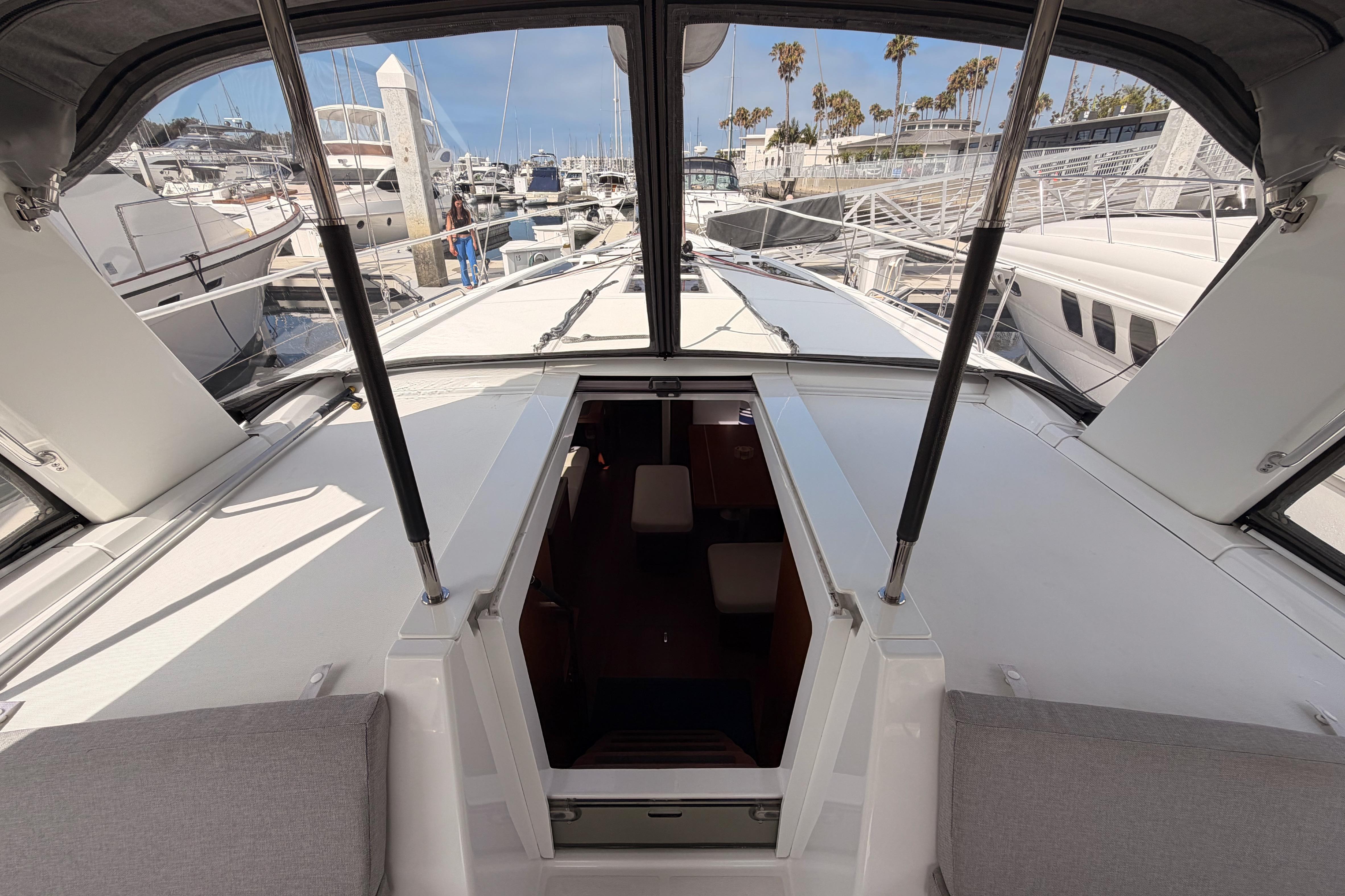 Beneteau Oceanis 46.1 yacht cockpit view, showcasing marina and open hatch, 2020 model.