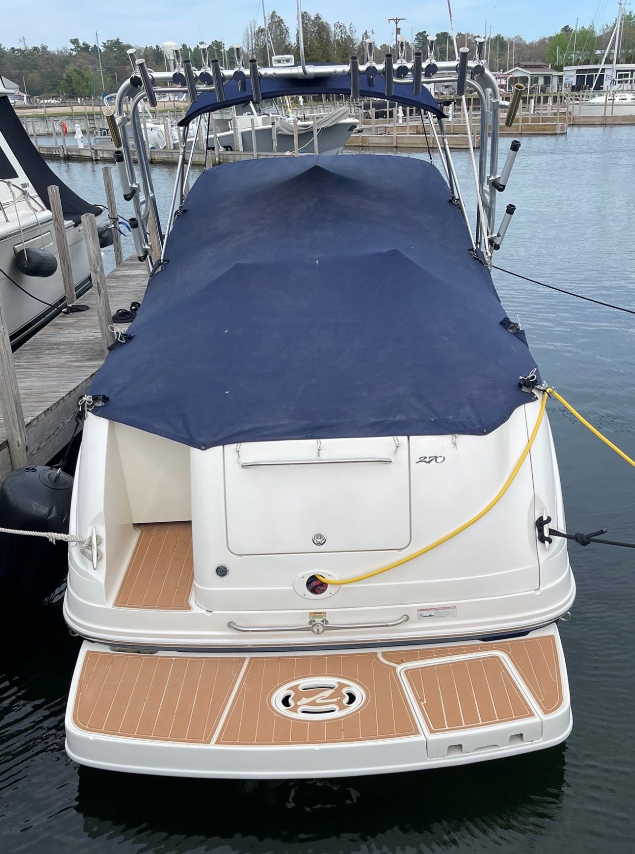 2006 Sea Ray 270 Amberjack docked with blue cover.