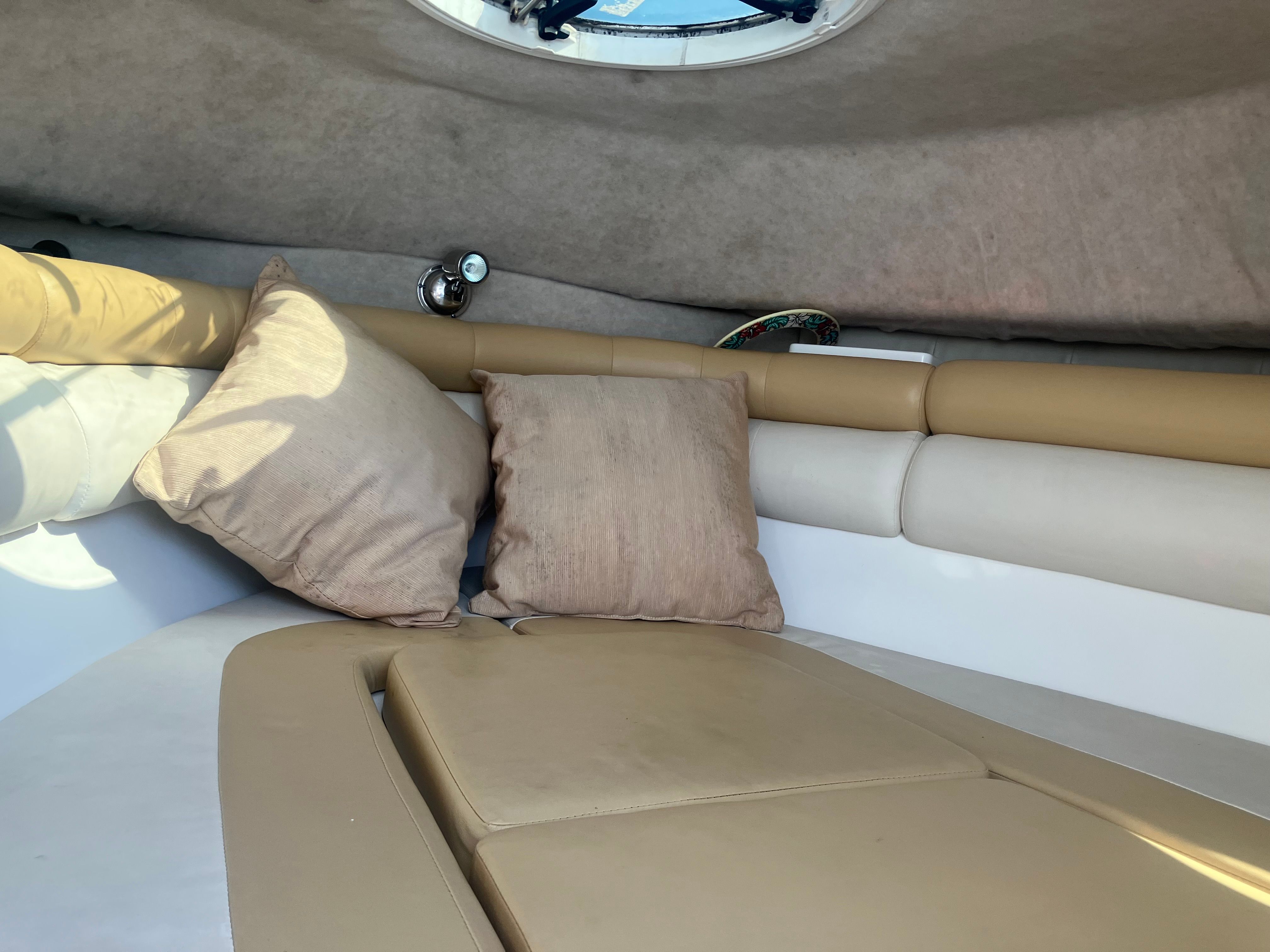 Interior of a 2010 Custom 216wa pro boat with beige cushions.