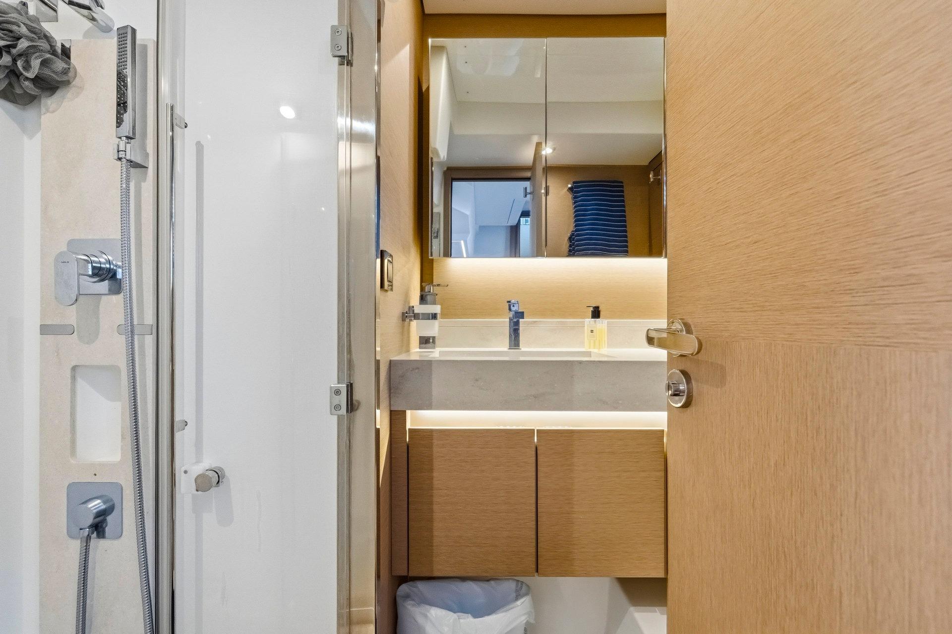 Modern bathroom interior on a 2022 Prestige 520 yacht, featuring sleek fixtures and wooden cabinetry.