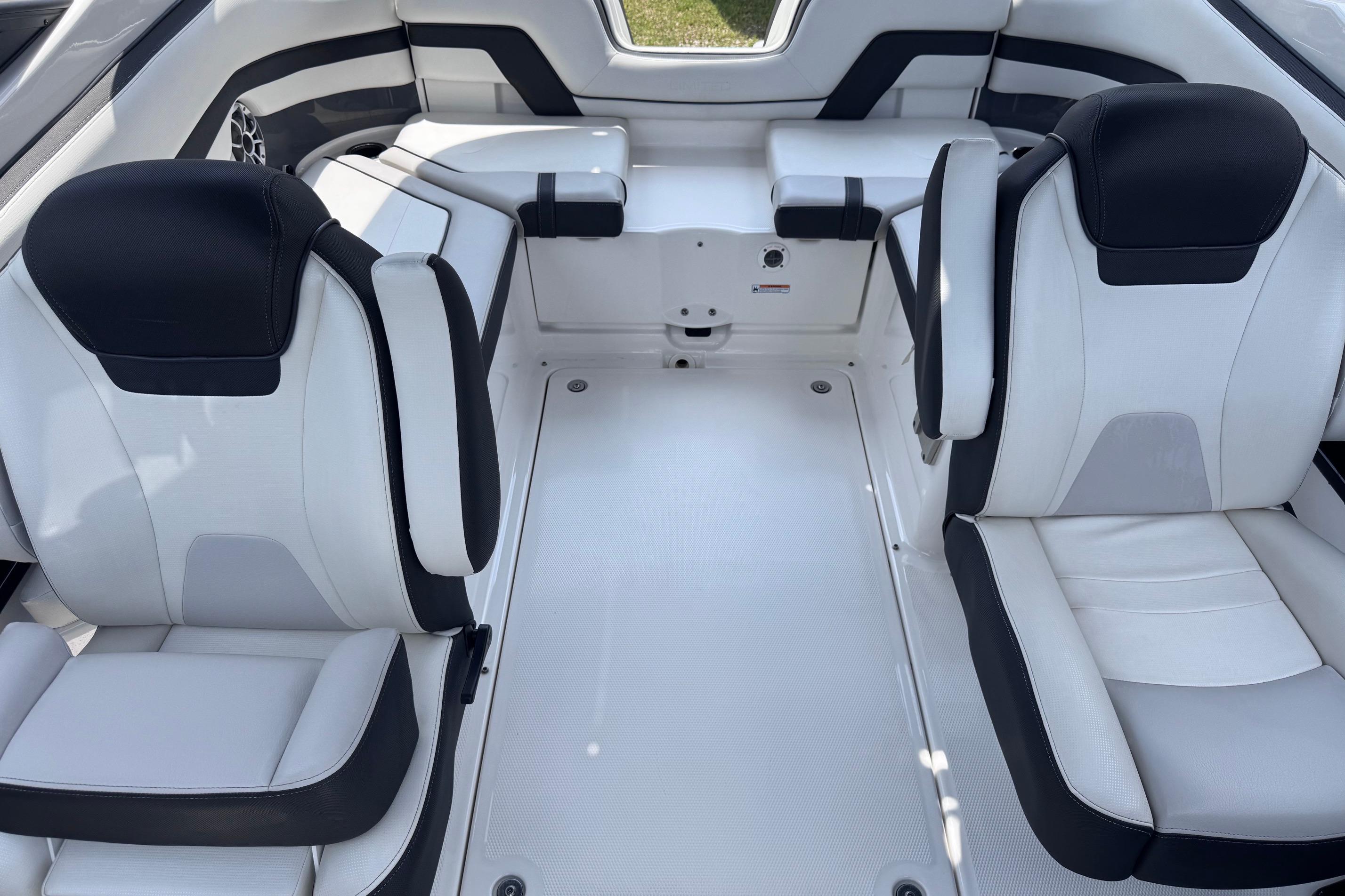 Interior of 2019 Yamaha Boats 242SE, featuring sleek white and black seating.