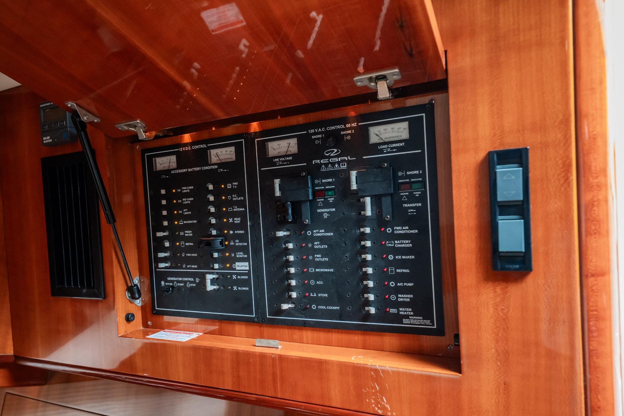 Control panel of a 2008 Regal Commodore 4460 yacht, featuring various switches and indicators.