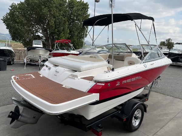2013 Regal 1900 boat with red and white exterior on a trailer.