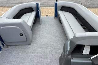 2026 Sun Tracker Party Barge 18 DLX interior with gray seating and carpet.