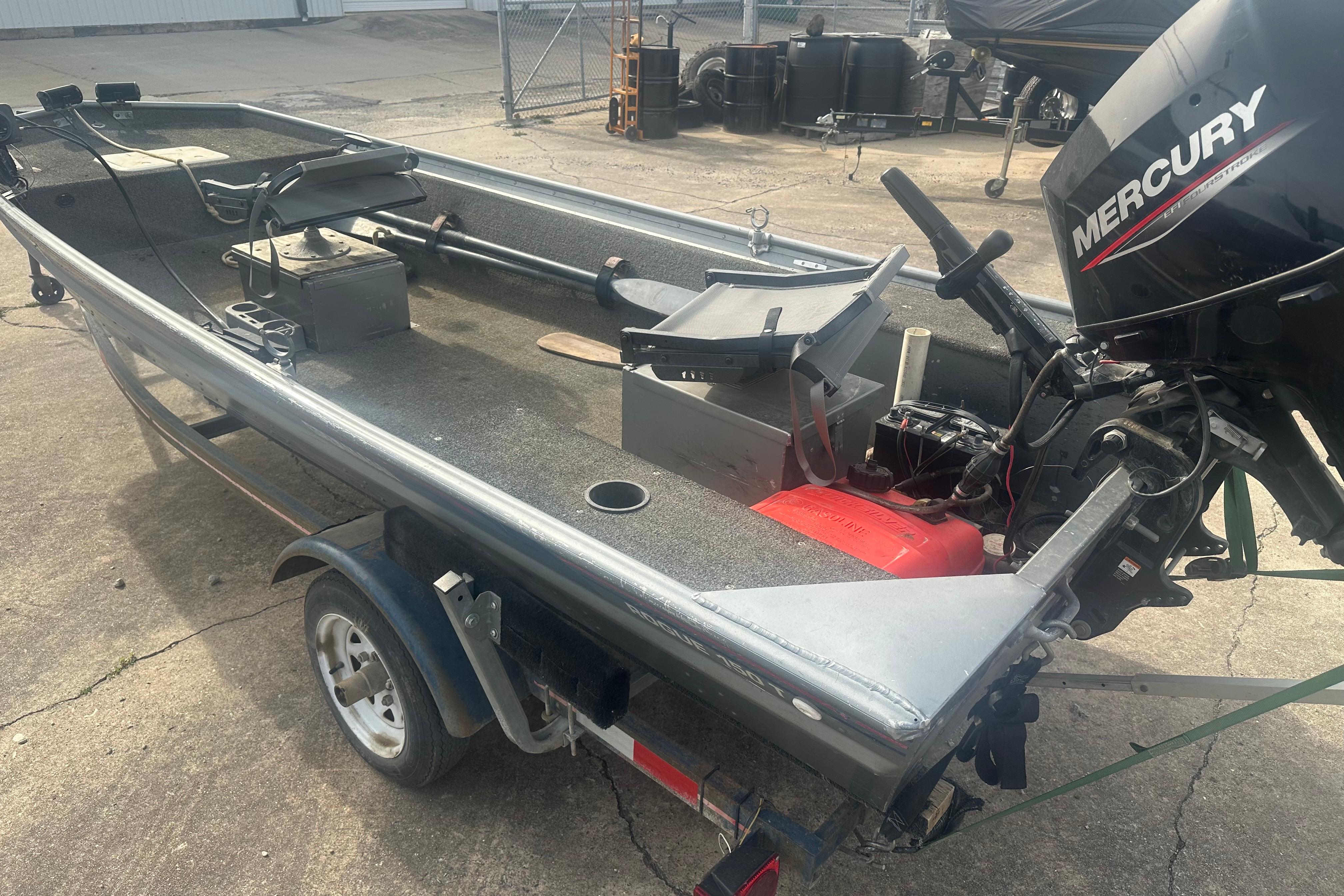 1991 Grumman Rogue 150 T boat with Mercury outboard motor on trailer.