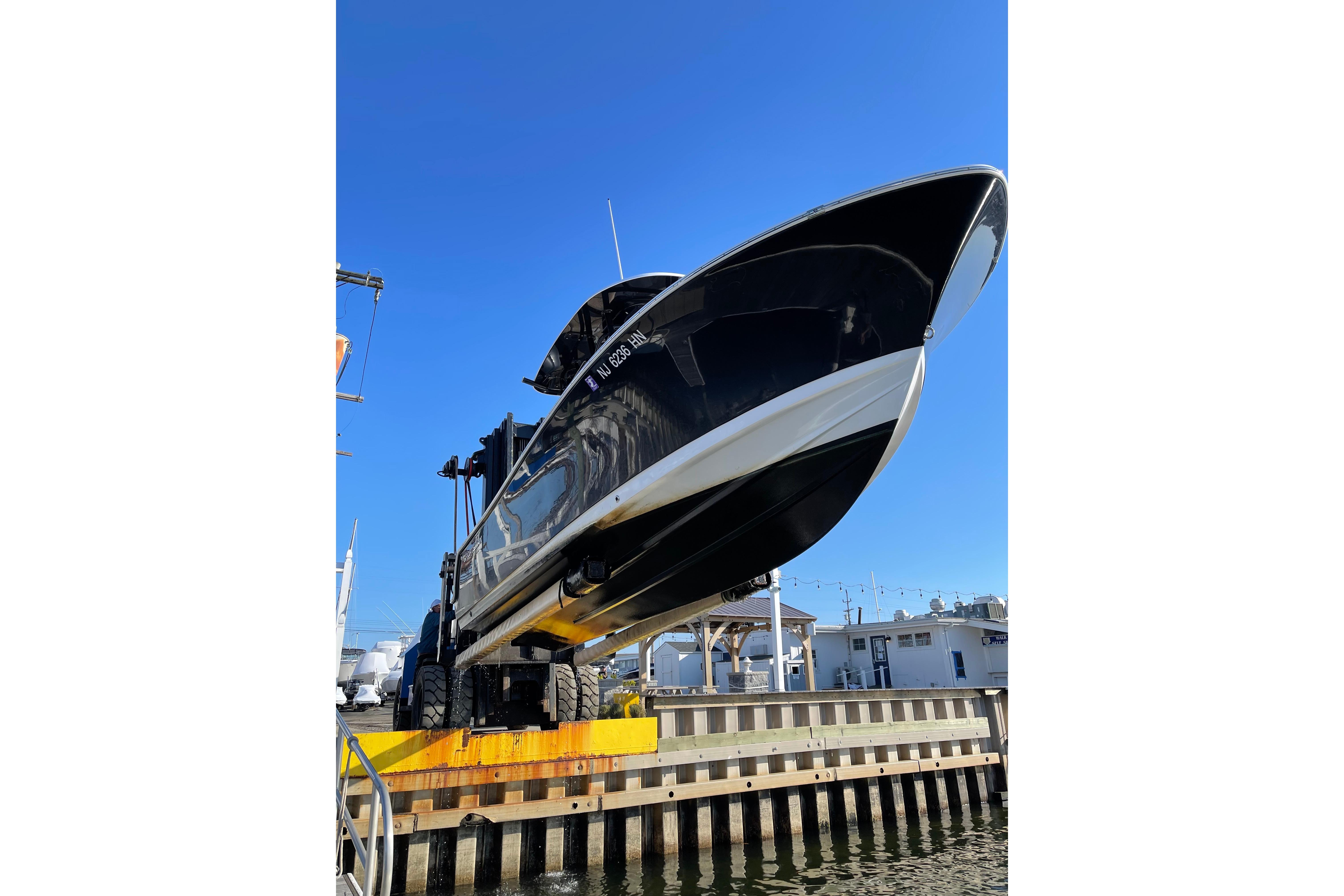 2019 Sportsman Heritage 231 Center Console boat lifted at marina.