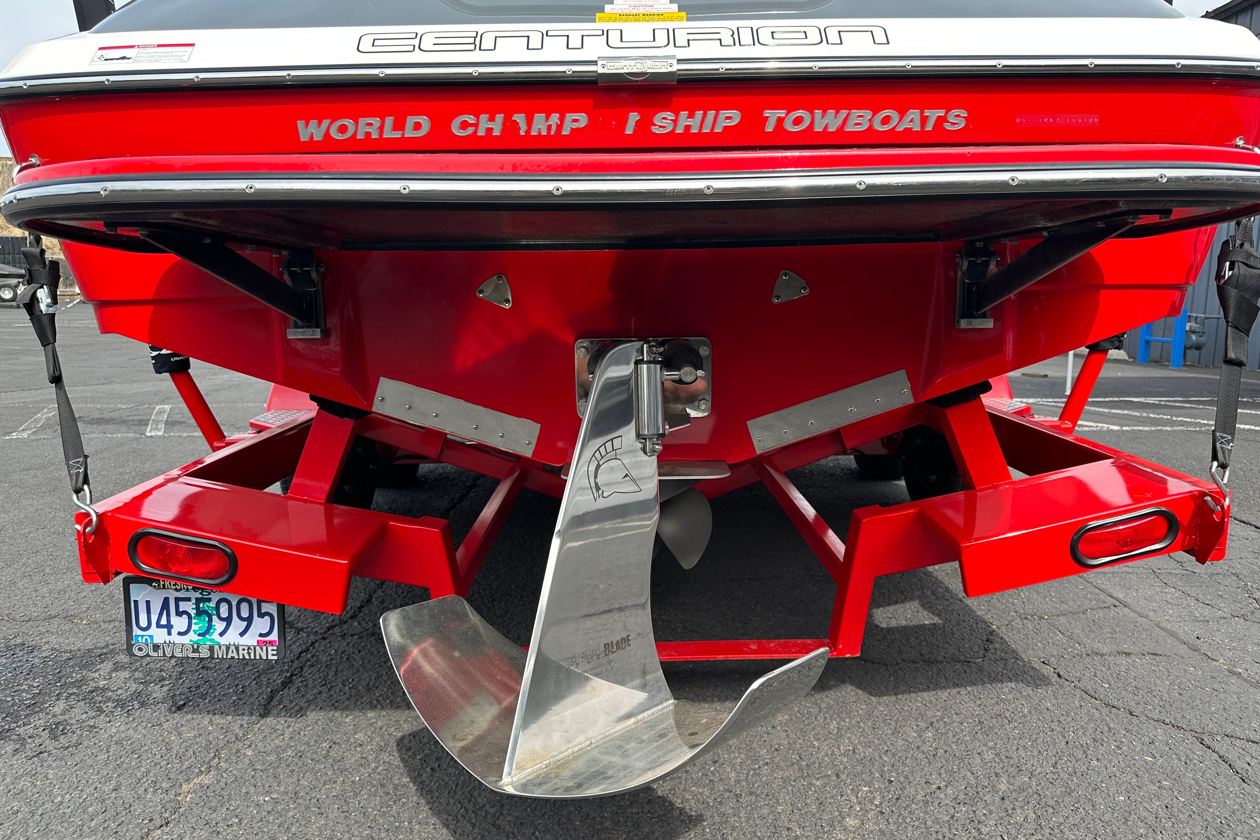 Rear view of a 2008 Centurion Enzo SV240 boat, showcasing propeller and red hull.