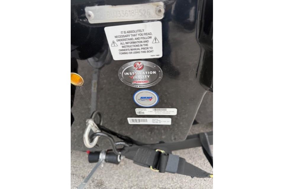 Close-up of Tahoe 1950 boat warning labels and installation quality sticker, 2026 model.