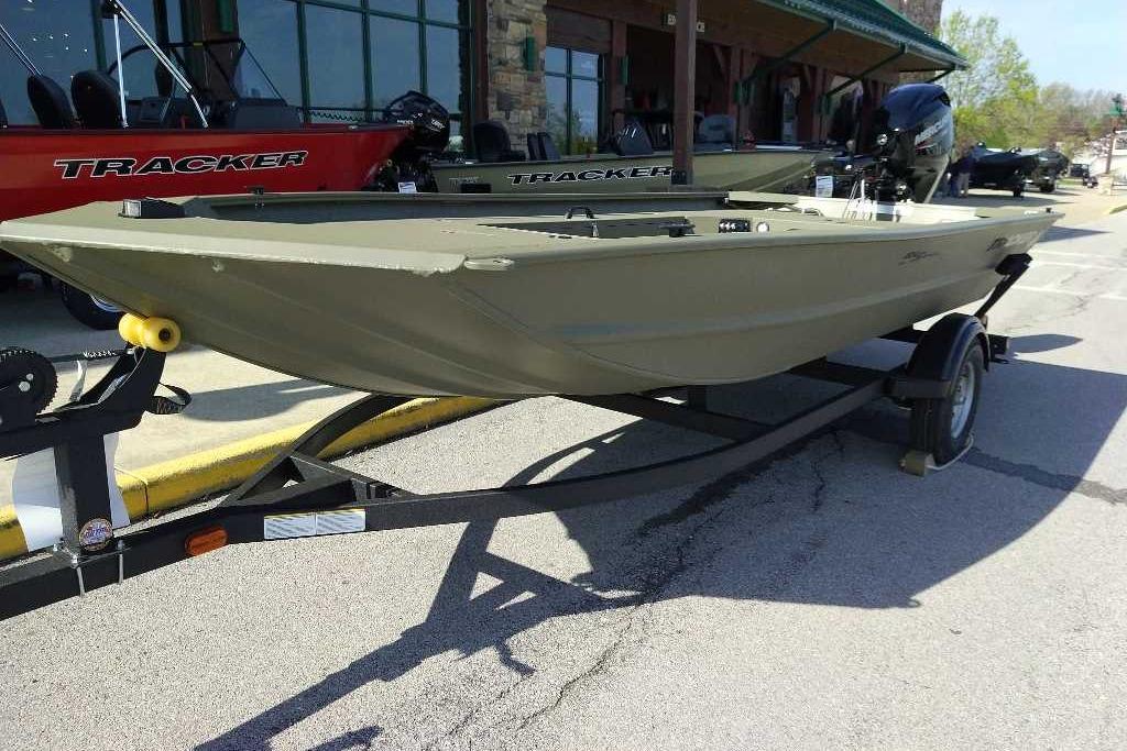 2026 Tracker Grizzly 1654 T Sportsman boat on trailer, parked outdoors.