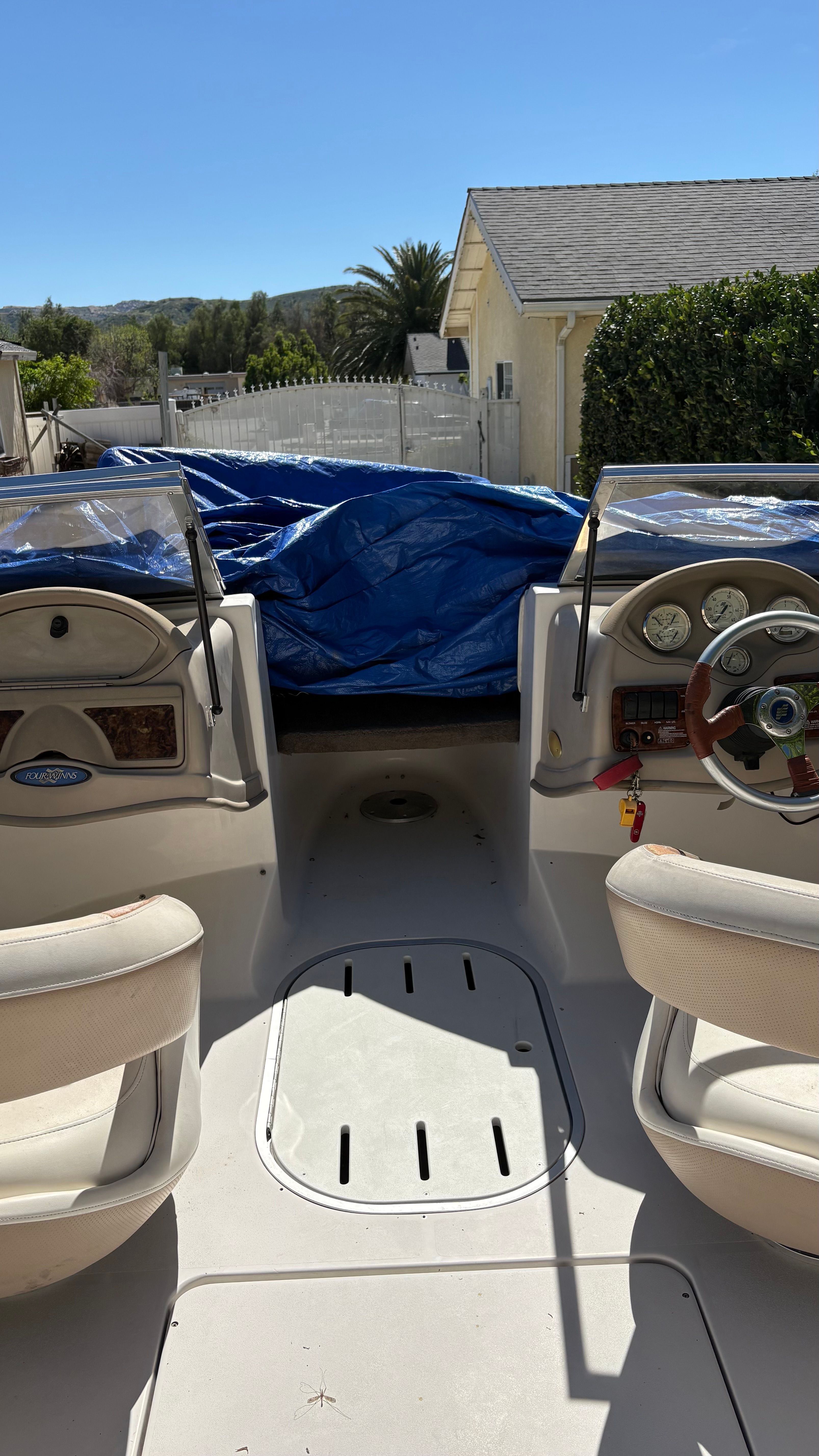 Interior of a 2007 Four Winns 203 Horizon boat with blue cover.