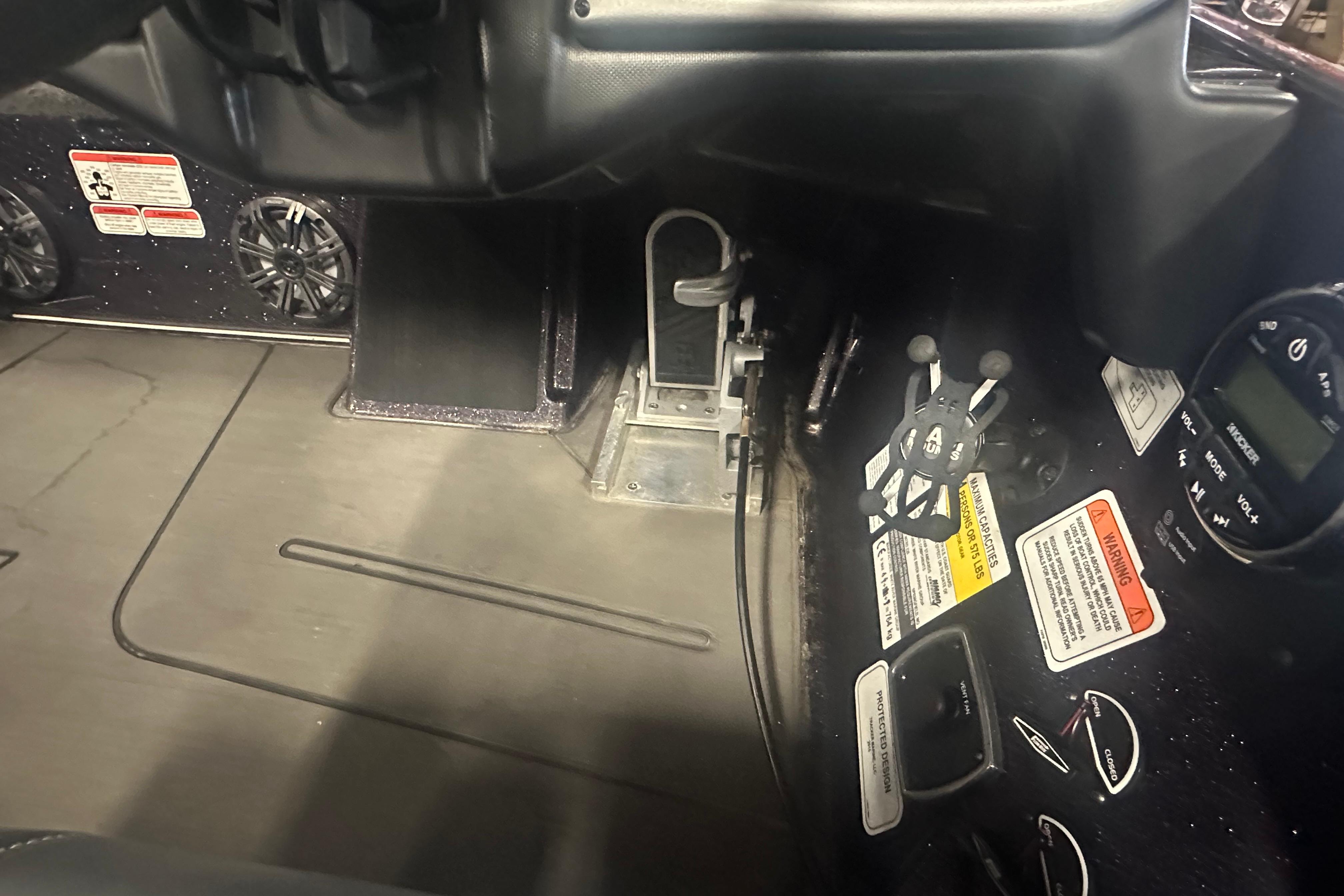 Interior view of a 2022 Nitro Z20 Pro boat dashboard with controls and warning labels.