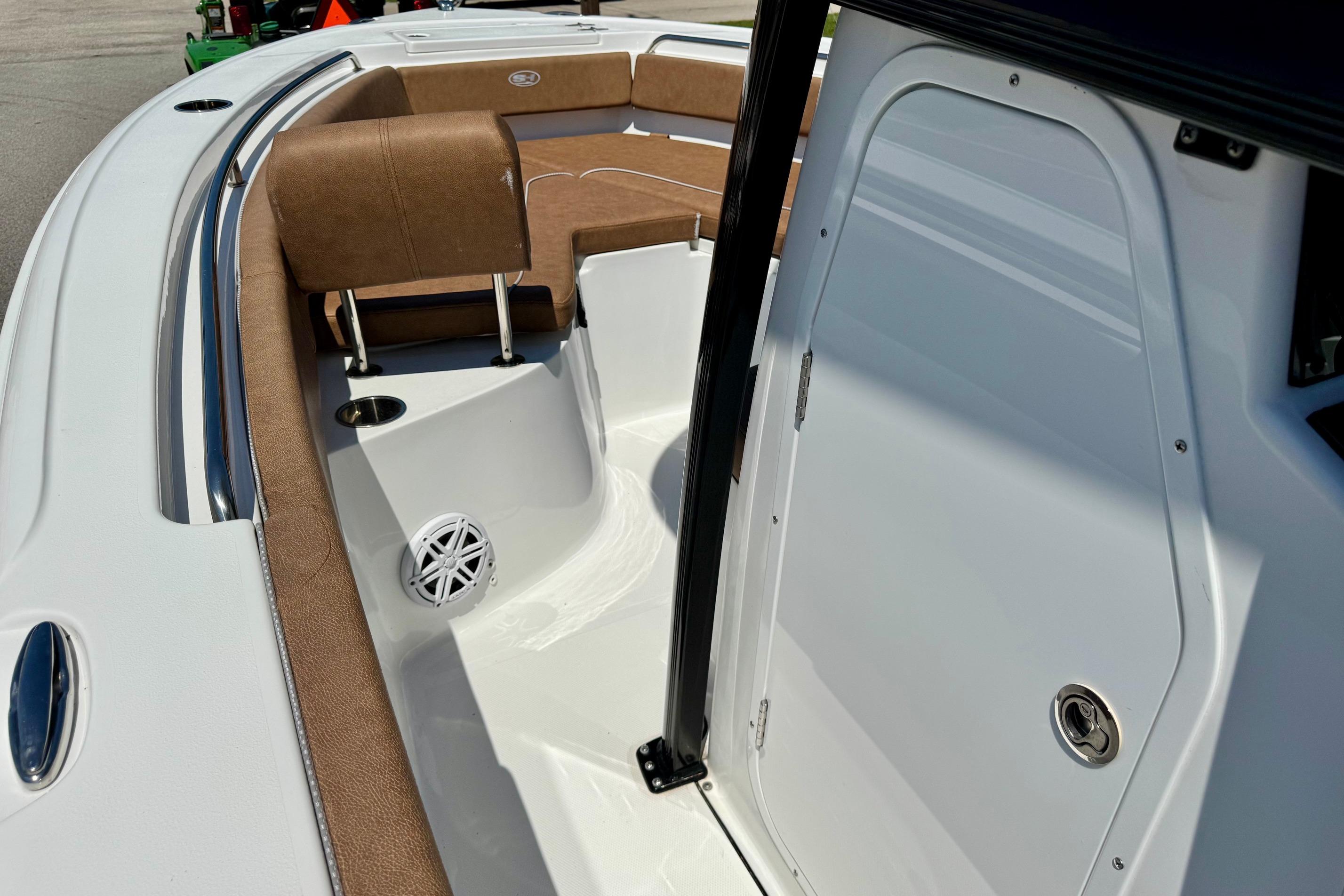 2025 Sea Hunt Ultra 219 boat interior with brown seating and white deck.