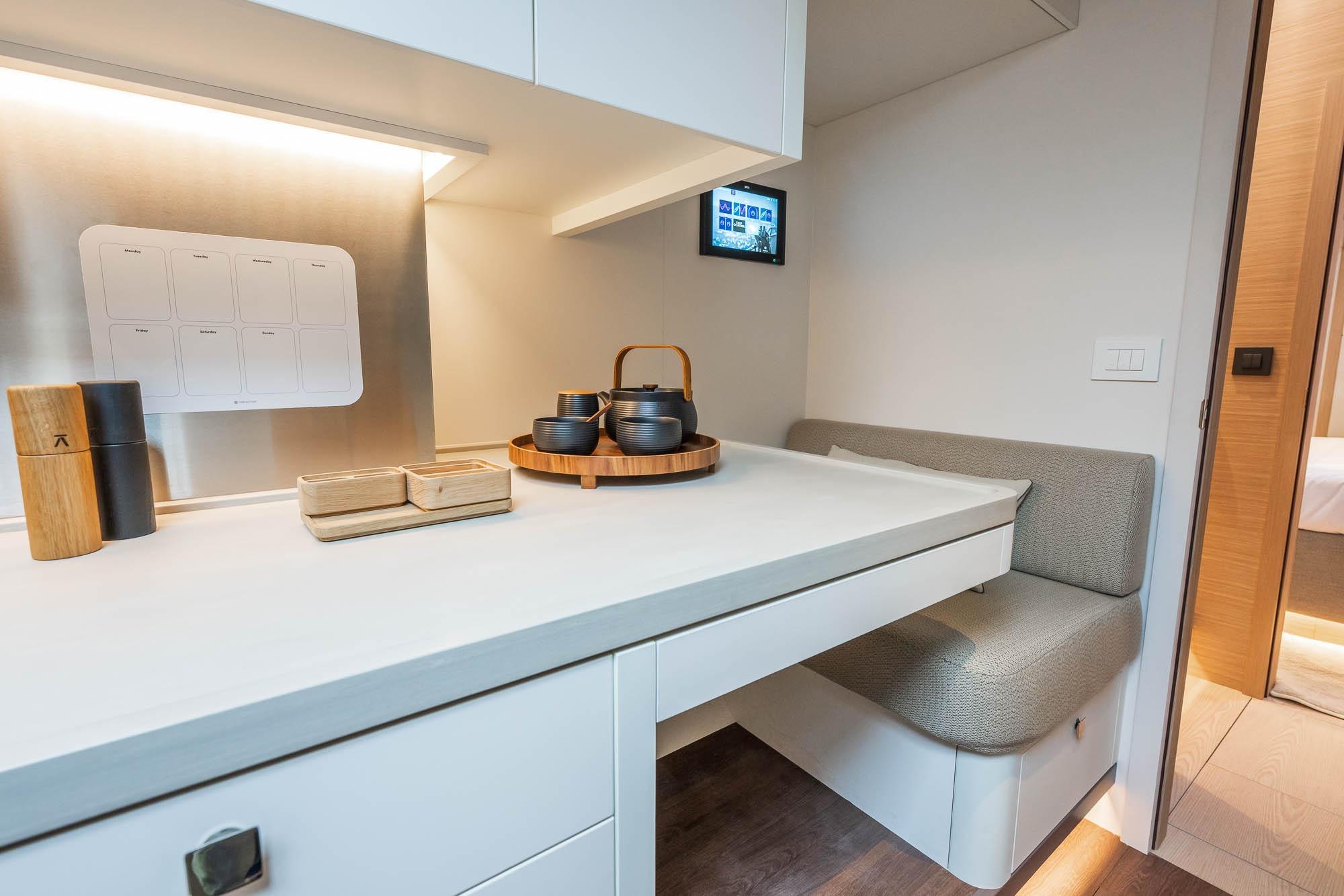 Modern interior of Lagoon Eighty 2 yacht, featuring a sleek dining area with elegant tableware.