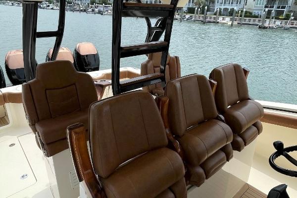 Luxurious seating on 2020 Scout 420 LXF boat with waterfront view.