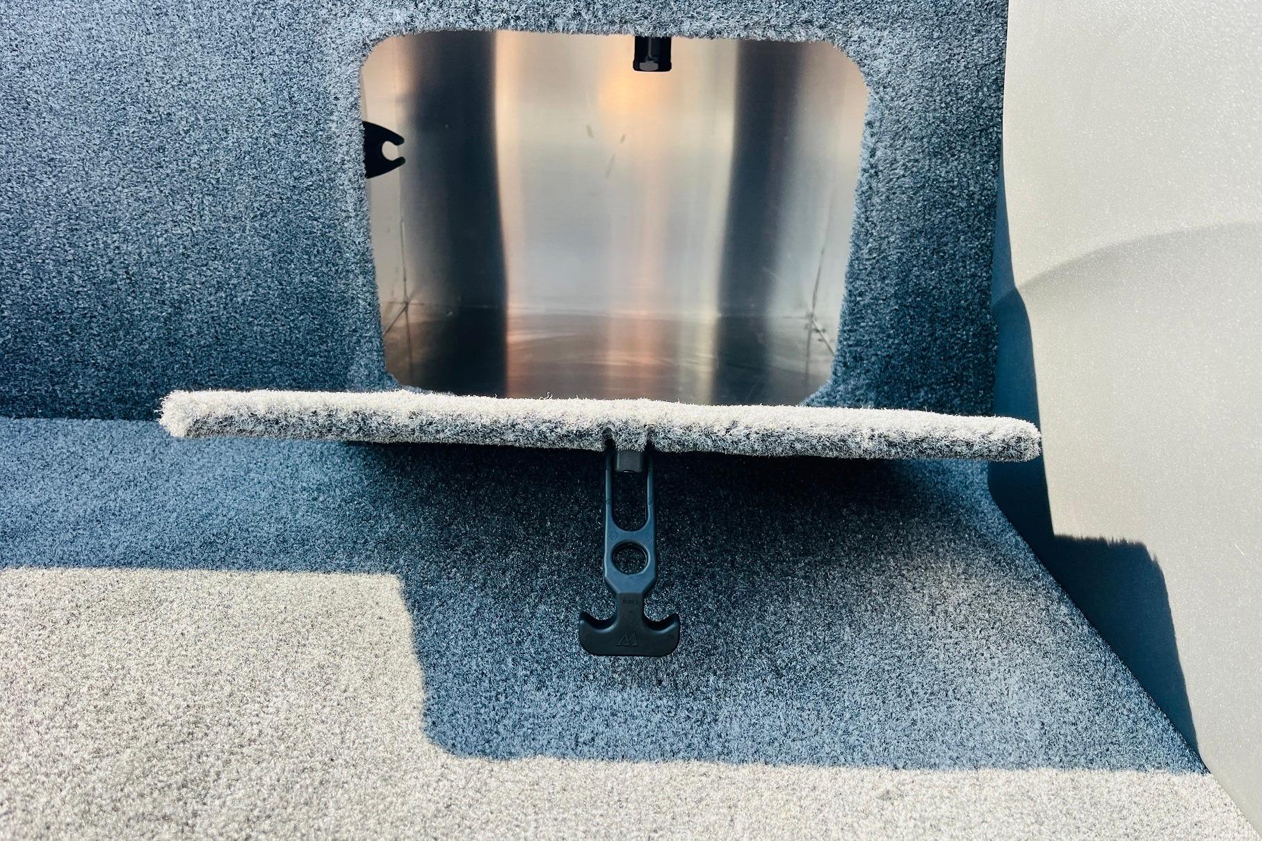 2026 Tracker Bass Tracker Classic XL boat storage compartment with carpeted interior.