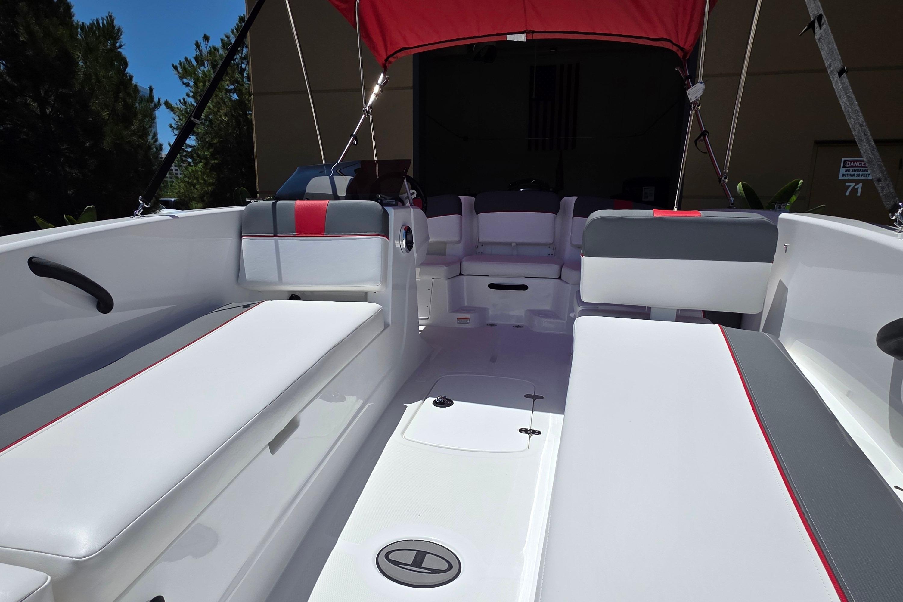 2026 Tahoe T18 boat interior with white and gray seating, red accents, and canopy.