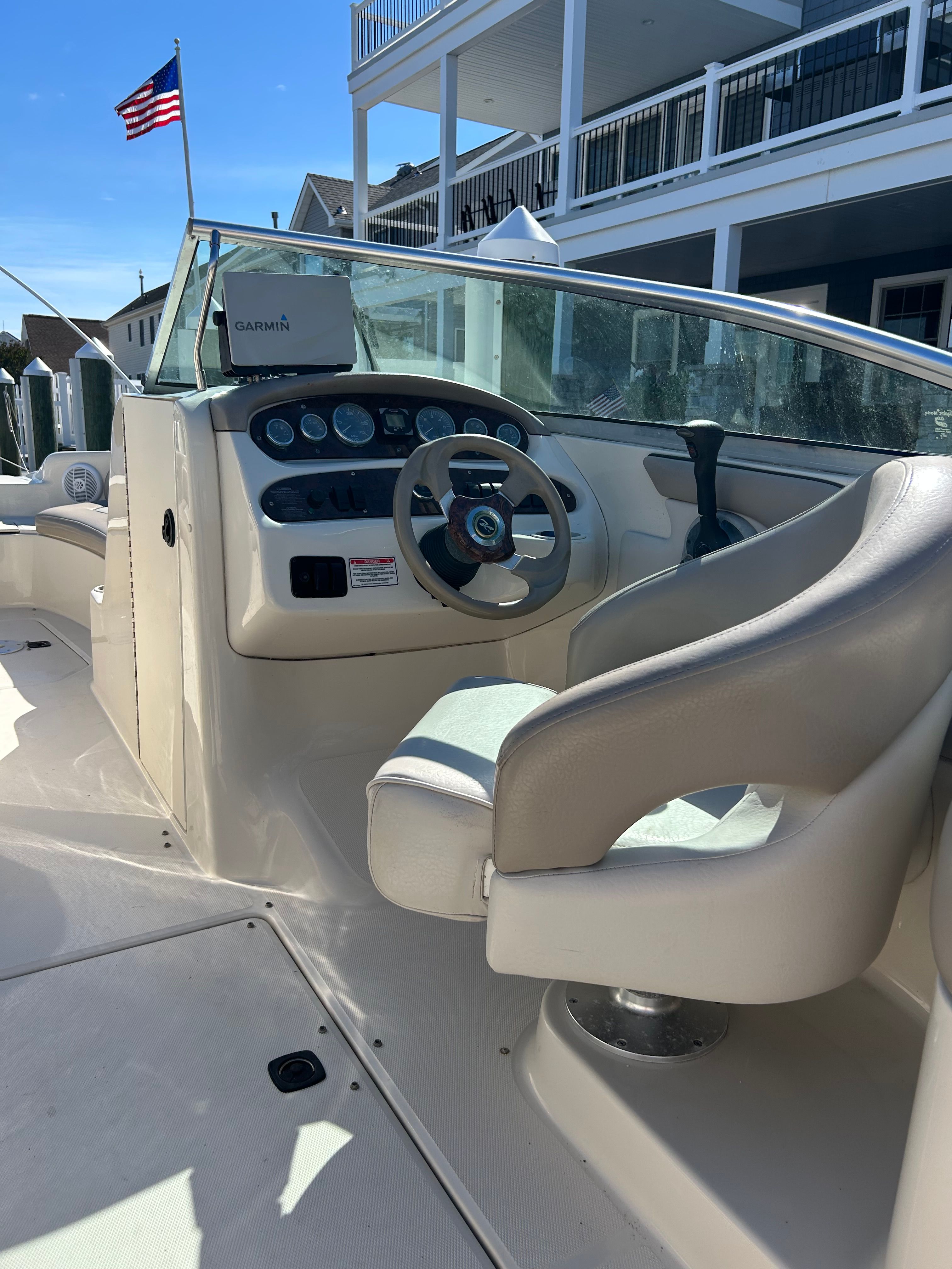Interior of a 2003 Sea Ray 240 Sundeck boat with helm station.