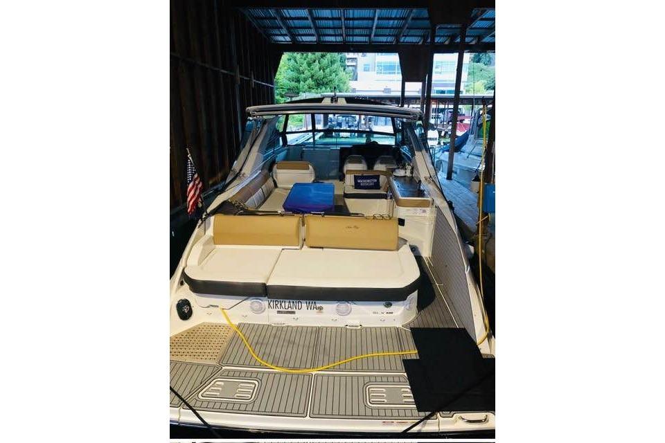 2018 Sea Ray SLX 400 boat docked, featuring spacious seating and modern design.