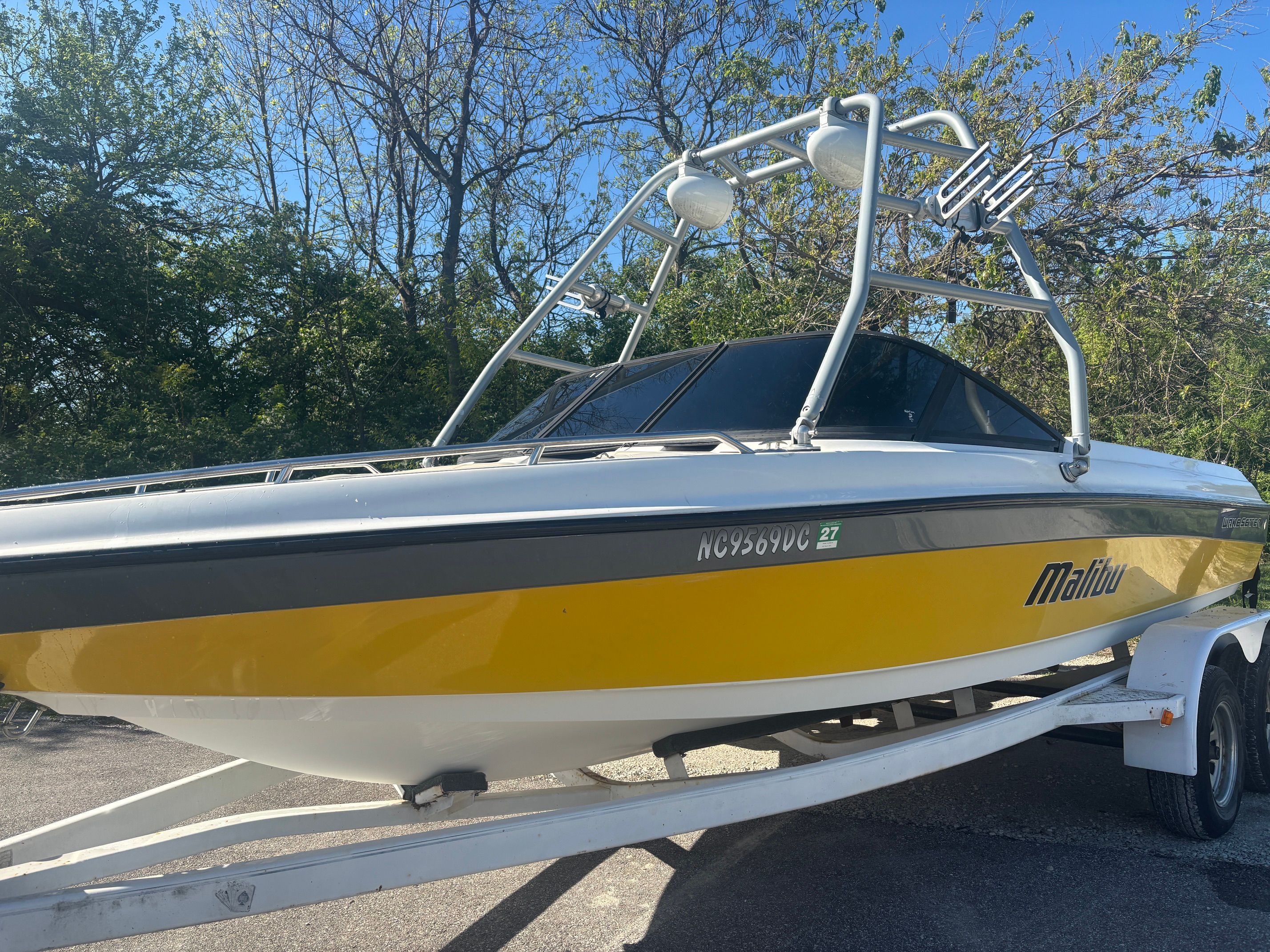 Yellow 2000 Malibu Wakesetter VLX boat on trailer.