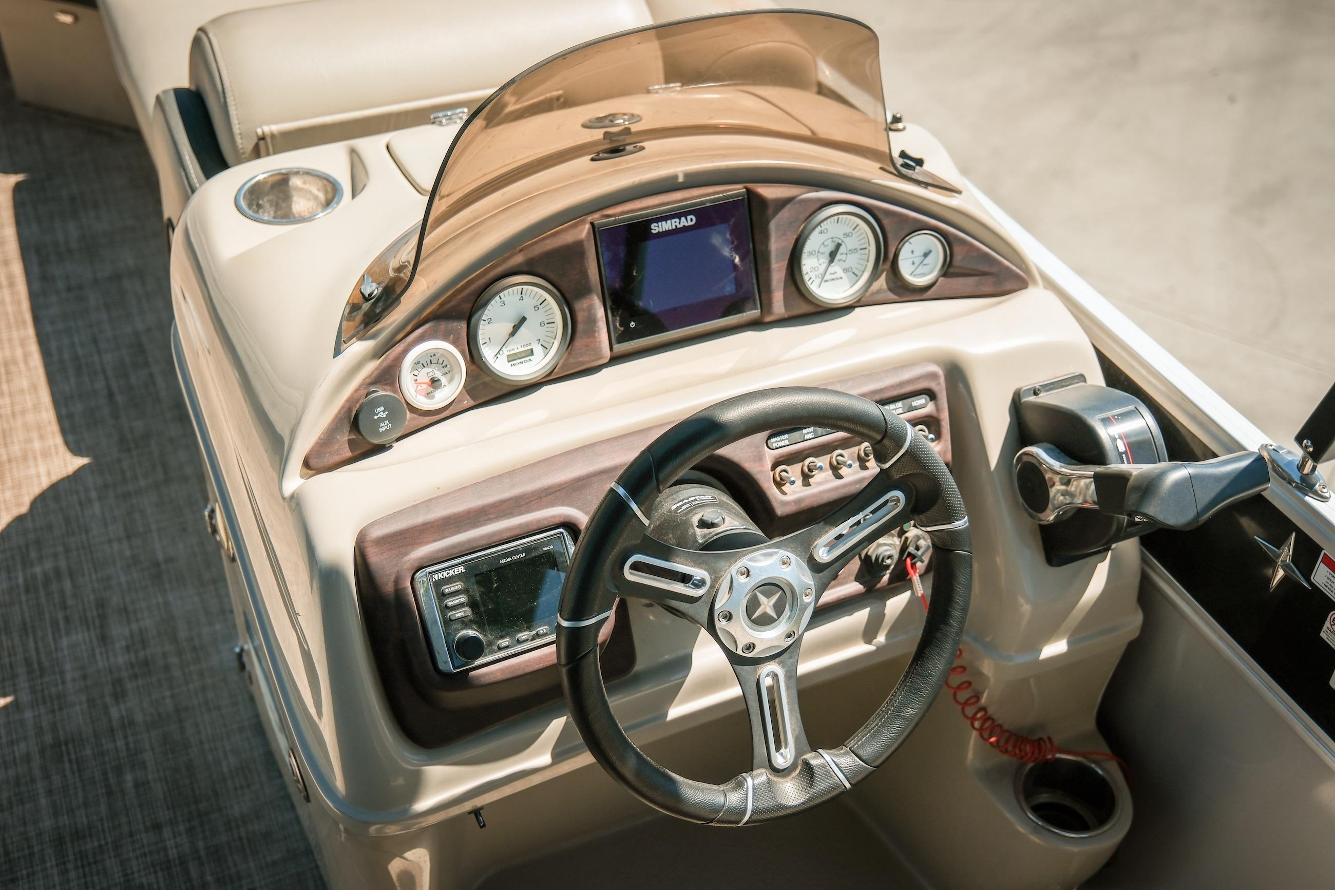 Steering console of 2019 Berkshire 25CLE STS boat with gauges and controls.