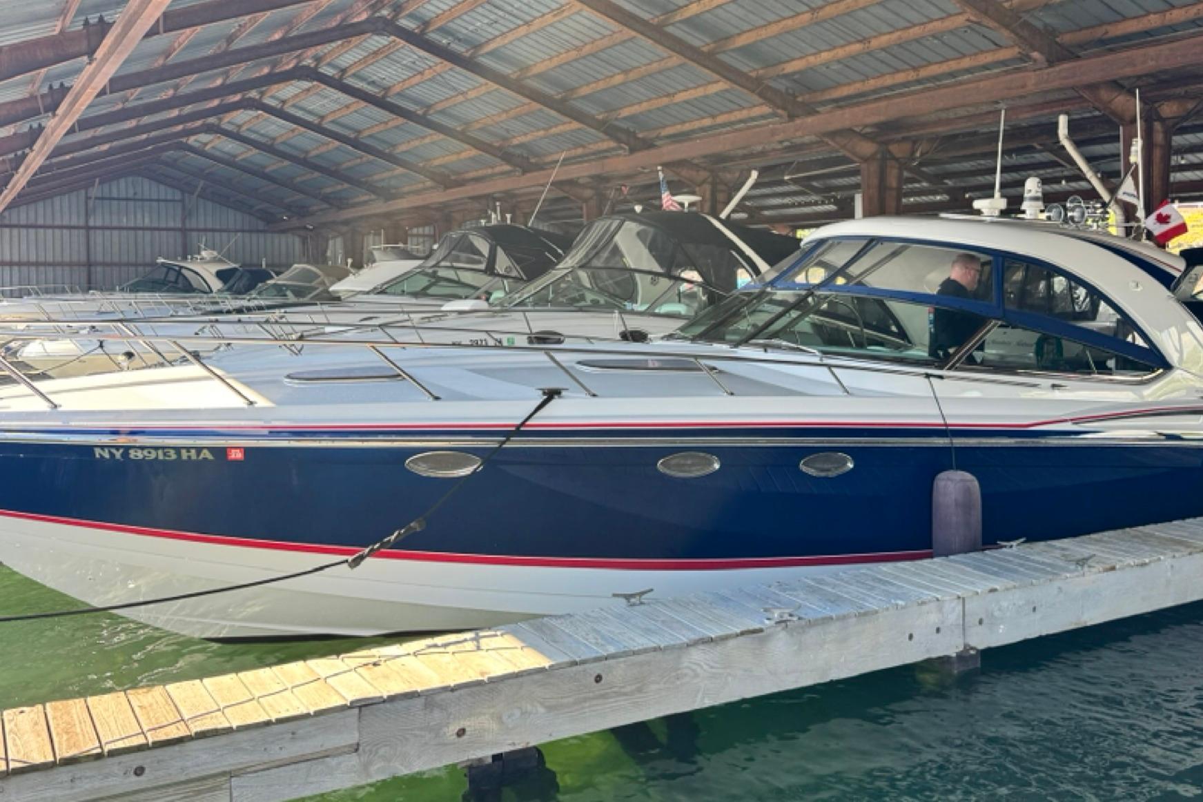 2008 Formula 400 Super Sport boat docked in a covered marina.