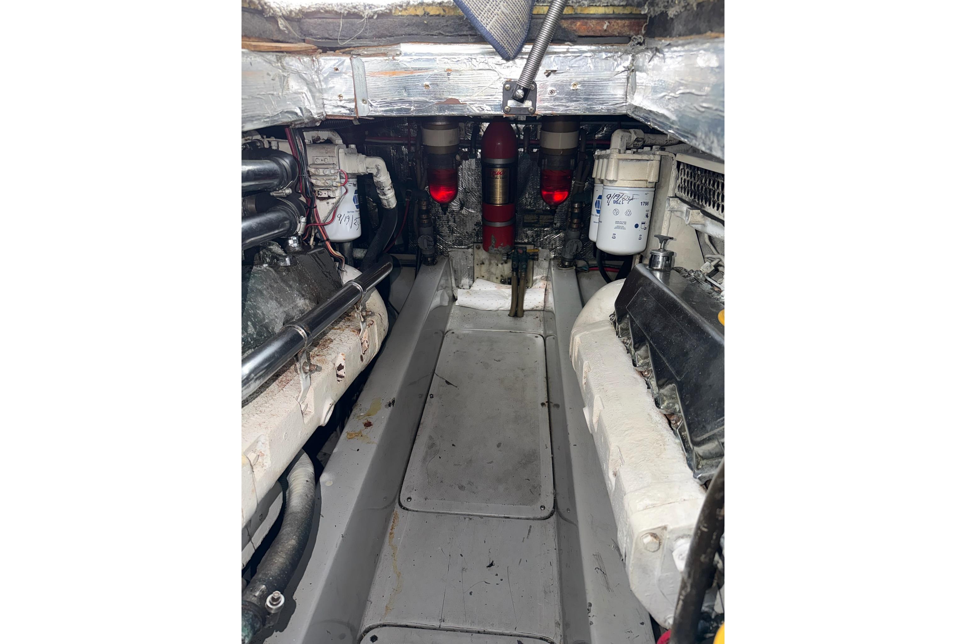 Engine room of a 1990 Mediterranean Sport Fish boat, showcasing mechanical components.