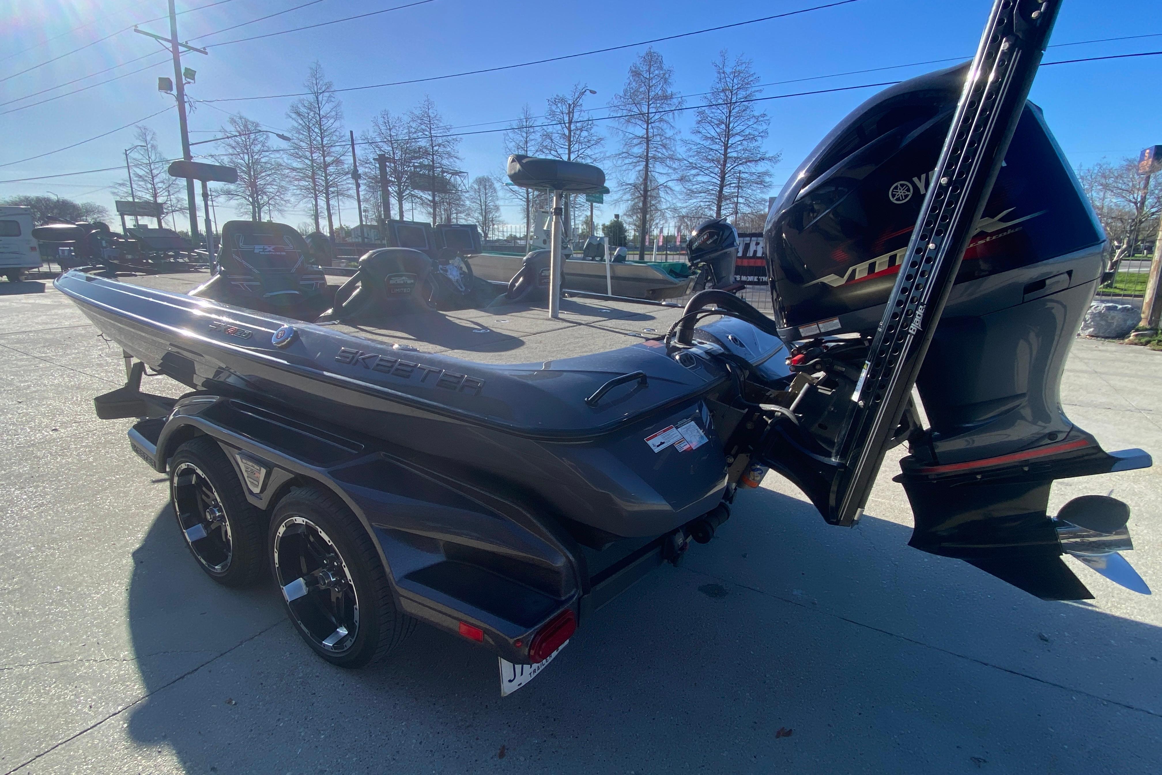 2020 Skeeter FXR20 Limited boat with Yamaha engine on trailer, parked outdoors.