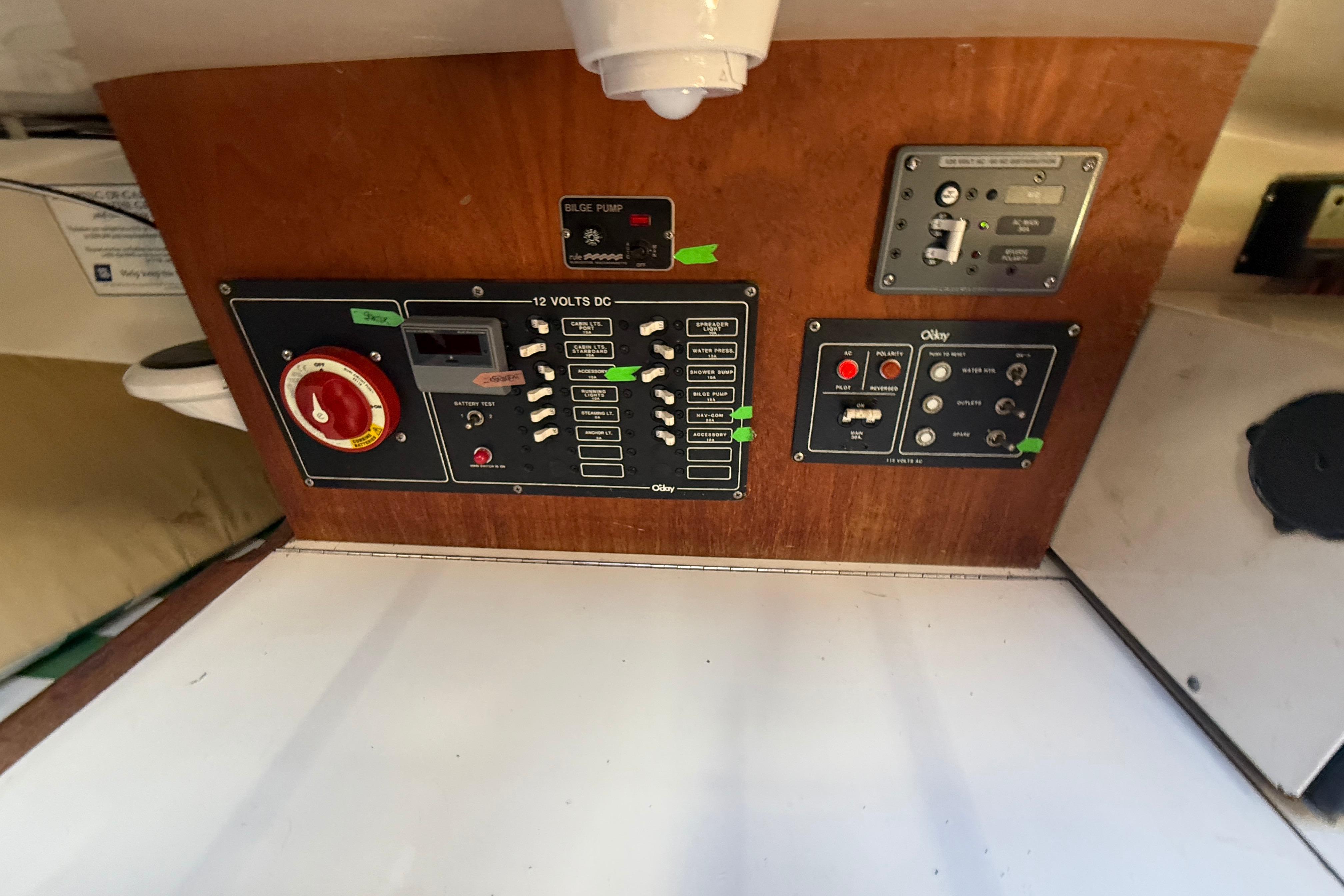 Control panel of a 1983 O'Day 34 sailboat, featuring various switches and indicators.