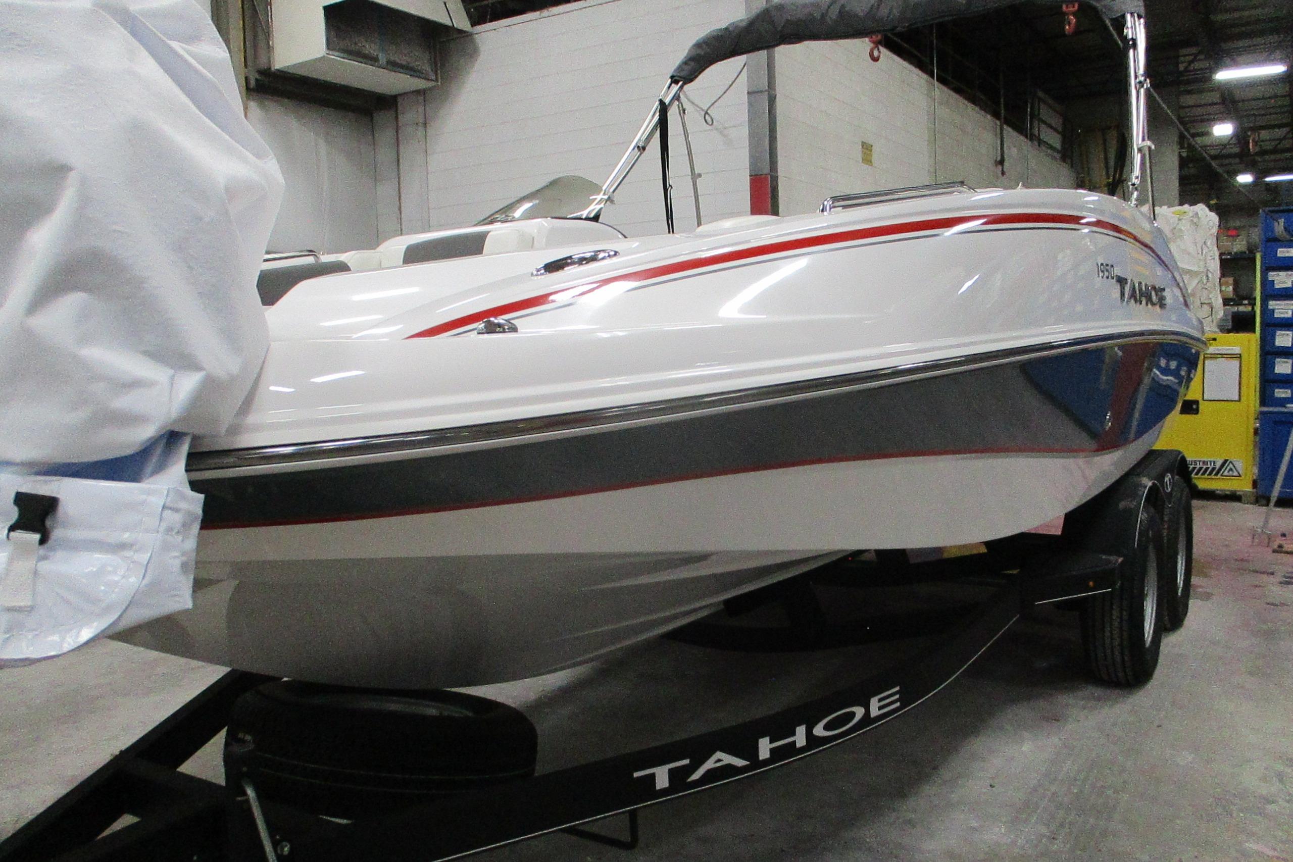 2024 Tahoe 1950 boat in a warehouse, showcasing sleek design and modern features.