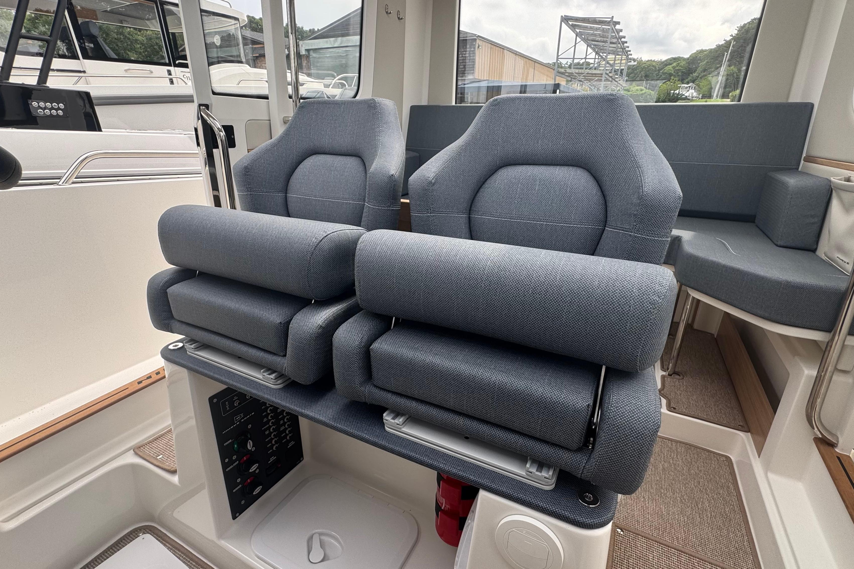 Interior of Nimbus Commuter 9 with gray seats and control panel.