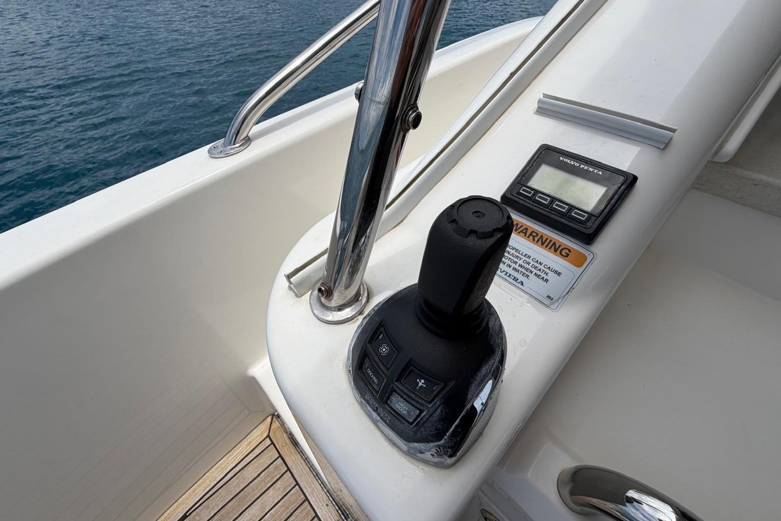 Control panel of 2018 Riviera 4800 Sport Yacht with joystick and display.