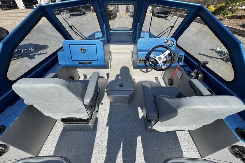 Interior of 2026 SeaArk Dynasty 2.0 boat with modern seating and control panel.