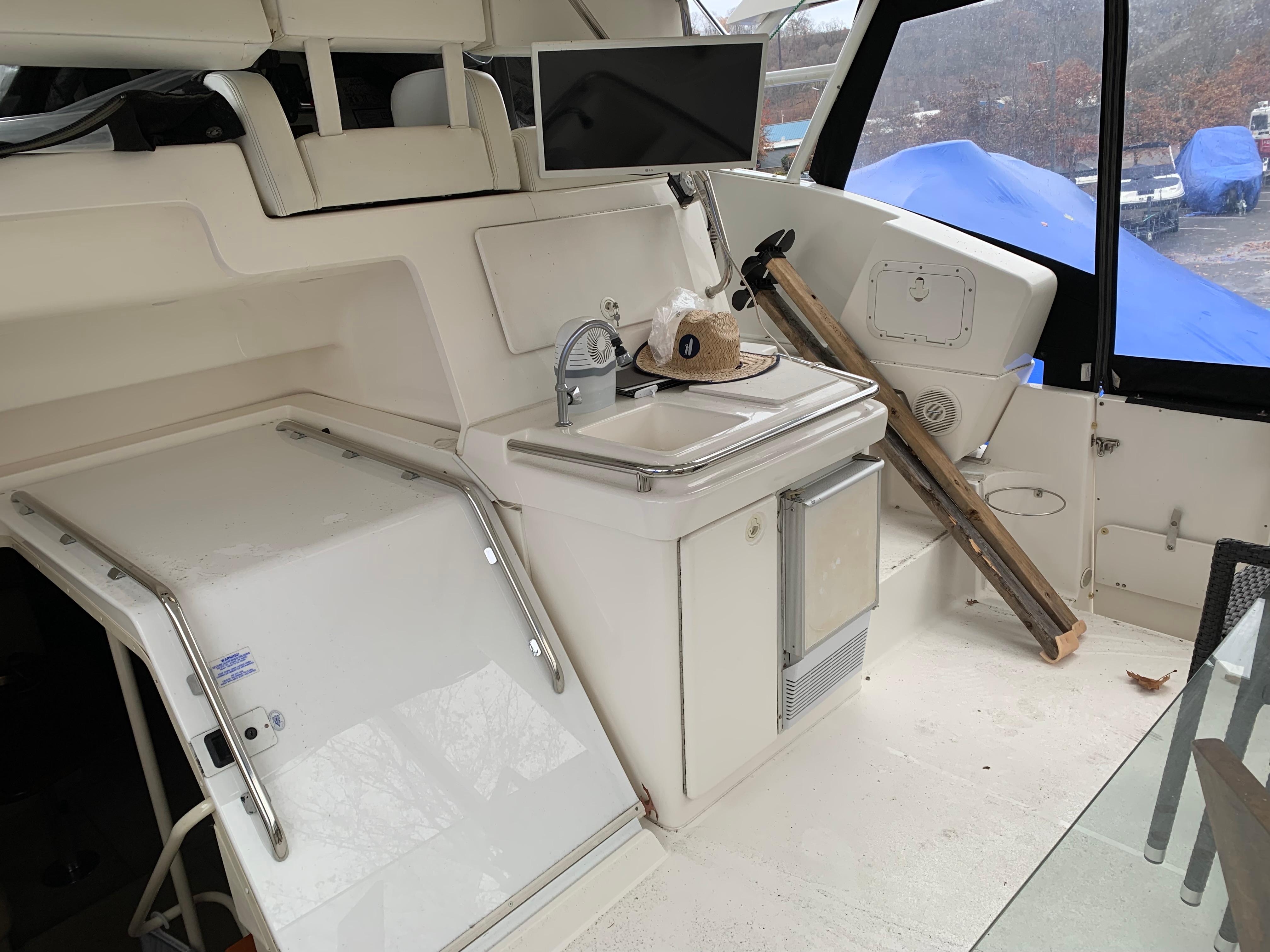 2000 Silverton 392 Motor Yacht interior with sink, storage, and seating area.