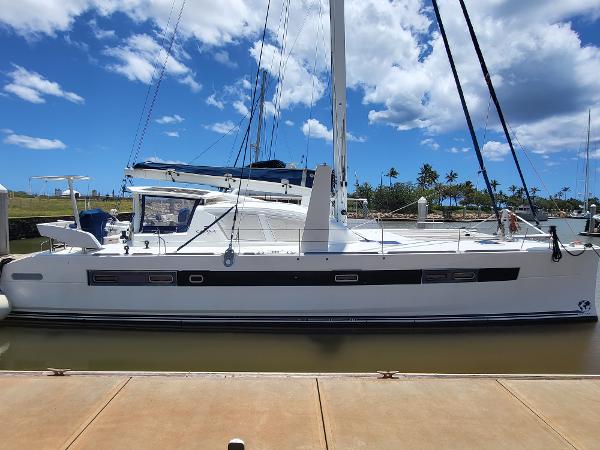 2009 Catana 65 catamaran docked at marina under blue sky.