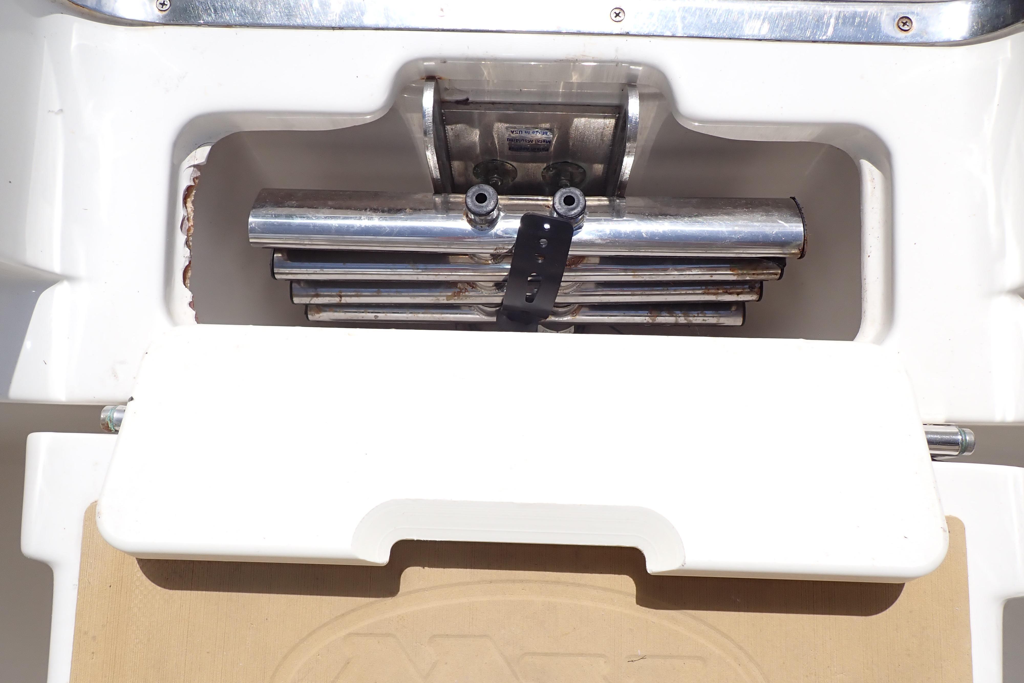2019 Key West 263 FS boat ladder compartment with stainless steel hardware.