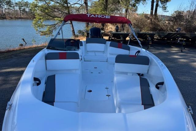 2026 Tahoe T16 boat with red canopy, docked by a serene lake.