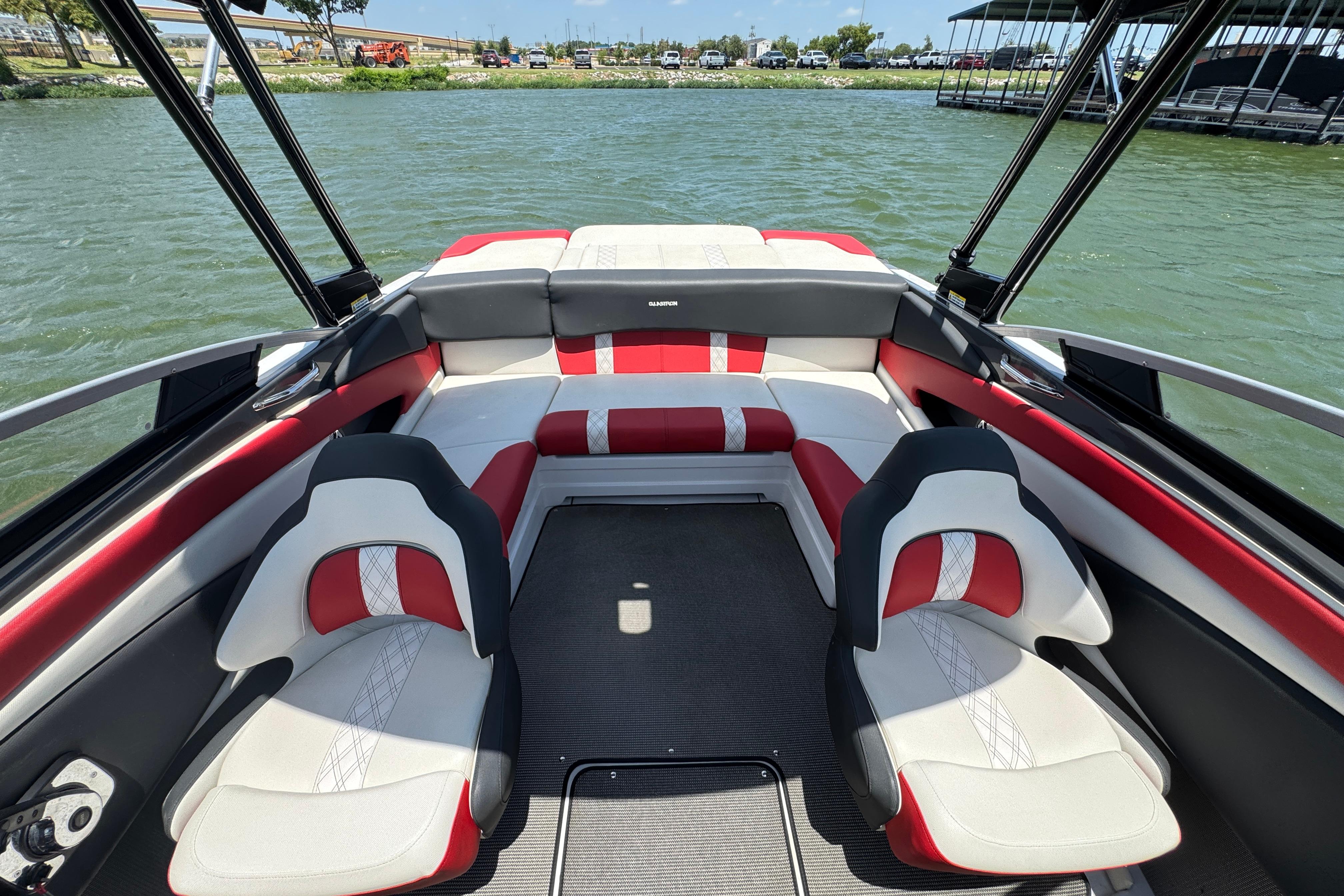 2017 Glastron GT 225 boat interior with red and white seating, docked on a lake.